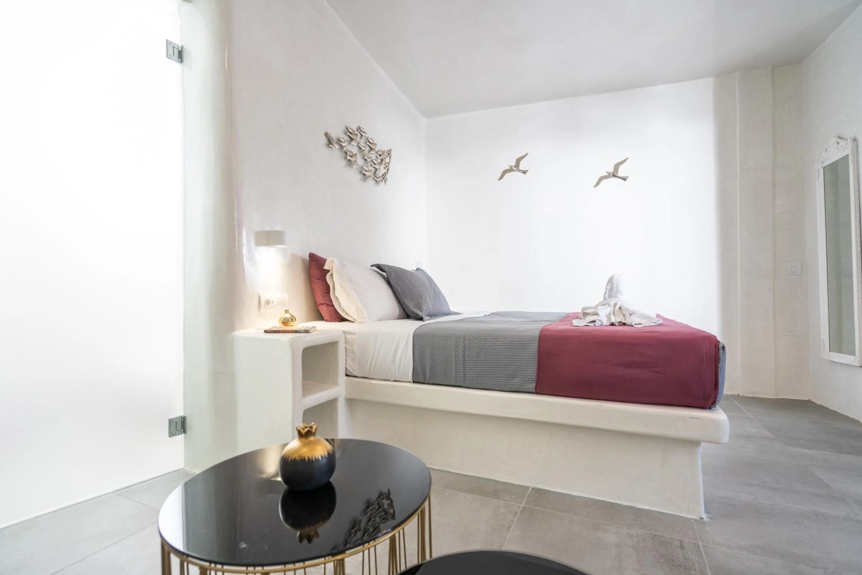 Bed in The Muses of Santorini Private Jacuzzi Suites