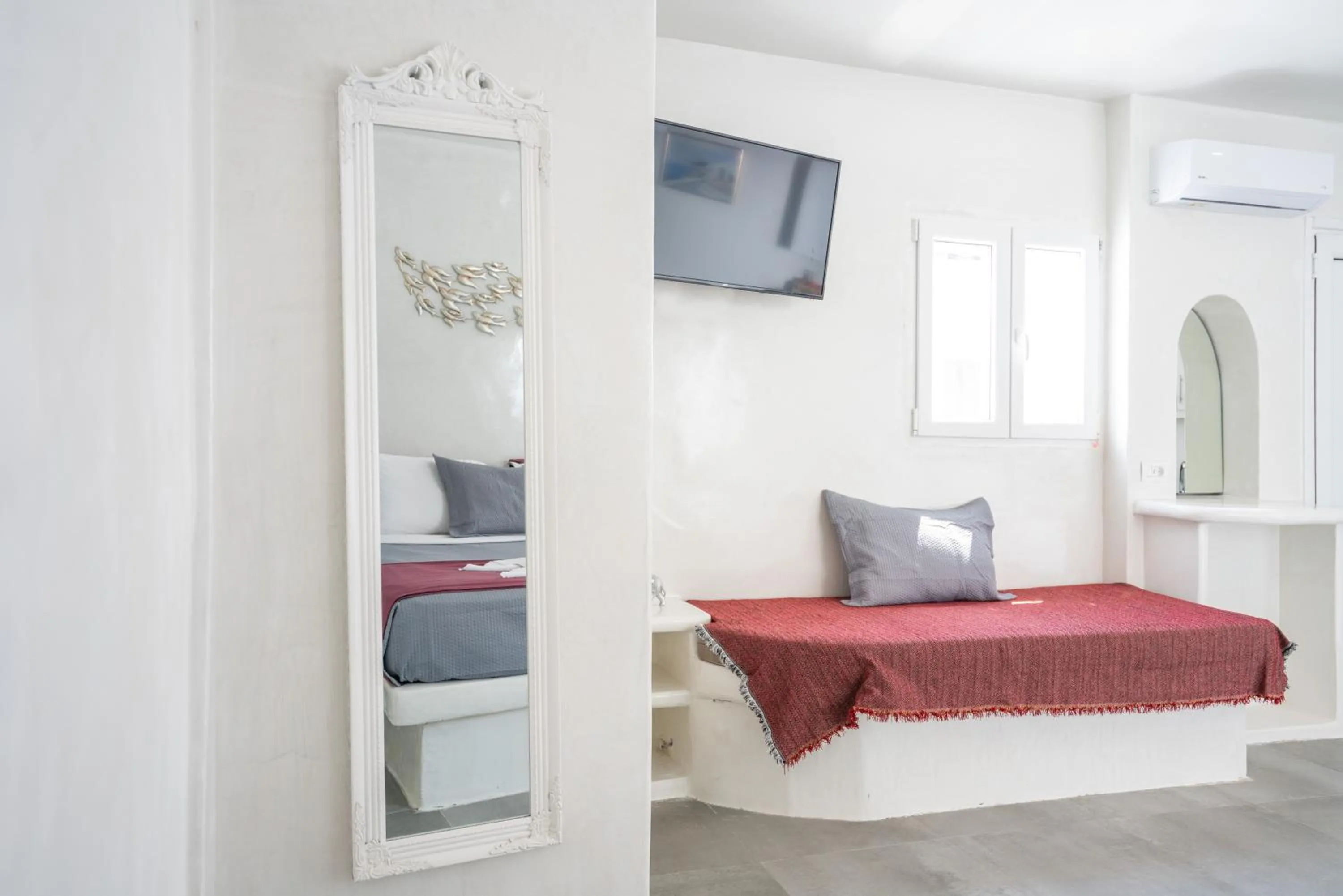 Living room, Bed in The Muses of Santorini Private Jacuzzi Suites
