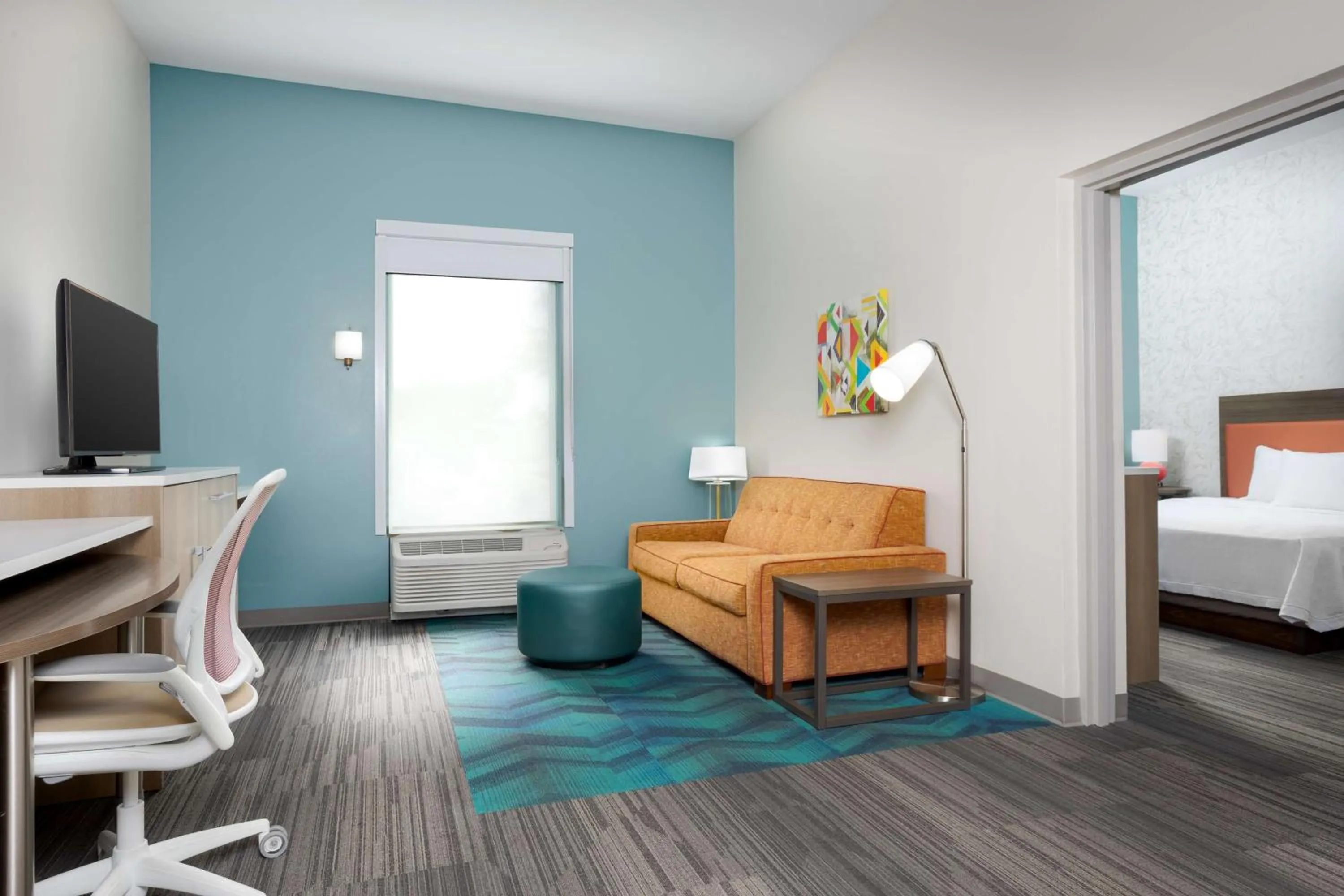 Living room, Bed in Home2 Suites By Hilton Clermont