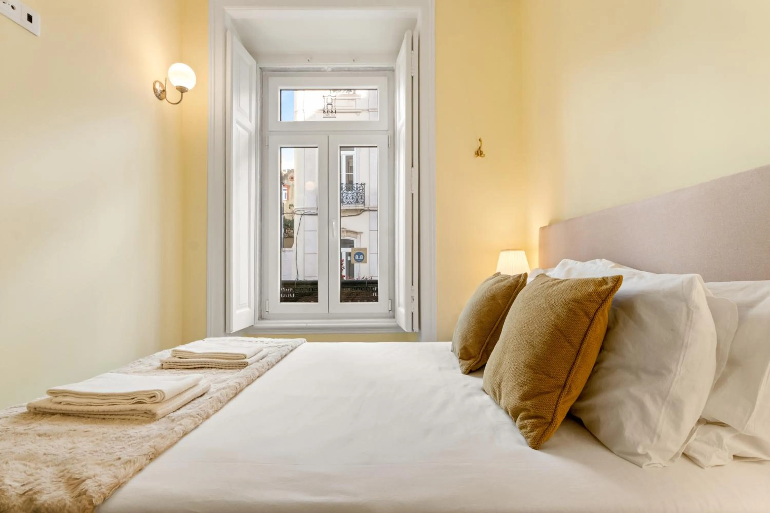 Bed in 1898 Home & Suites