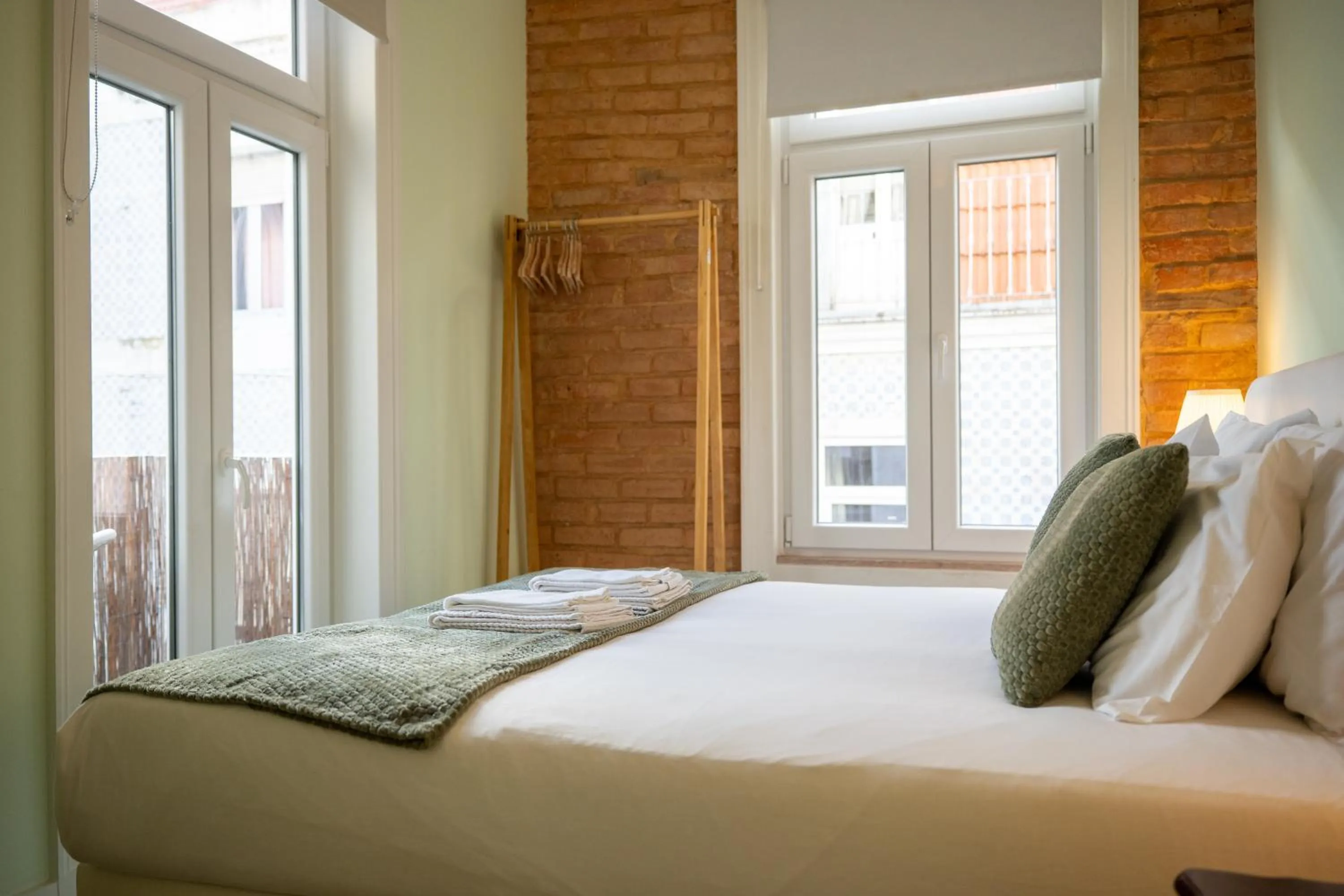 Bed in 1898 Home & Suites