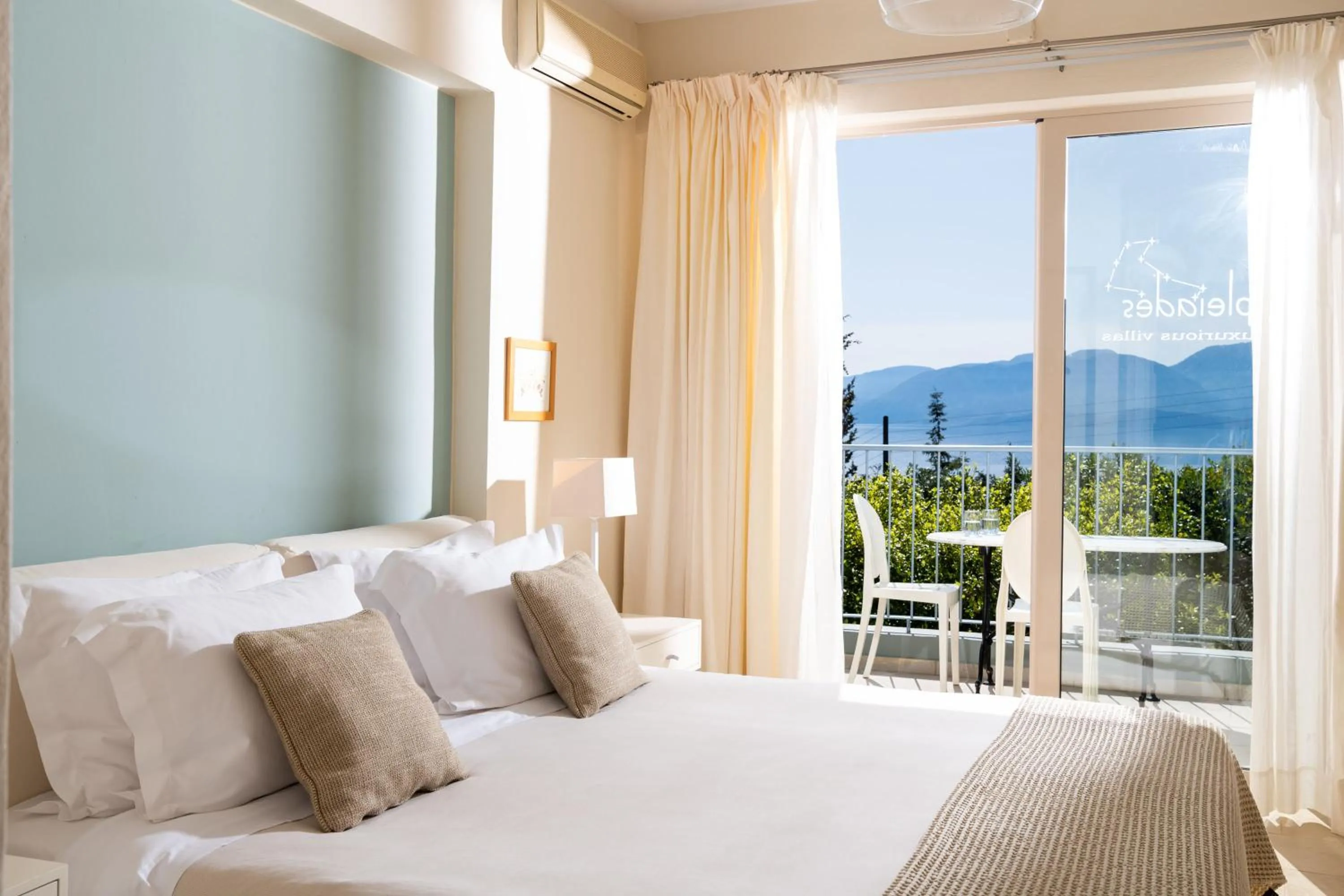 Bed in Pleiades Luxurious Villas