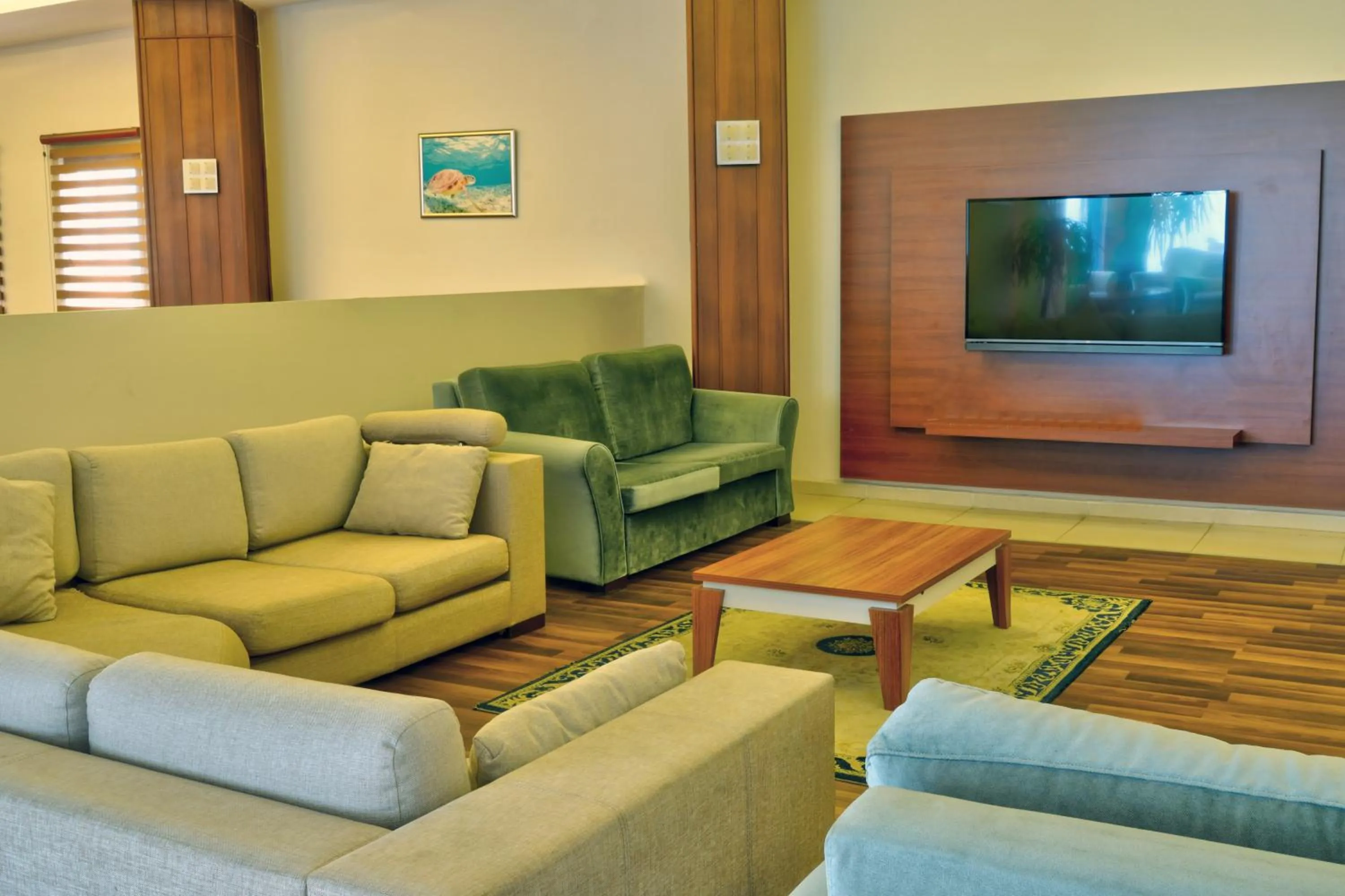 Communal lounge/ TV room in Blue Fish Hotel All Inclusive