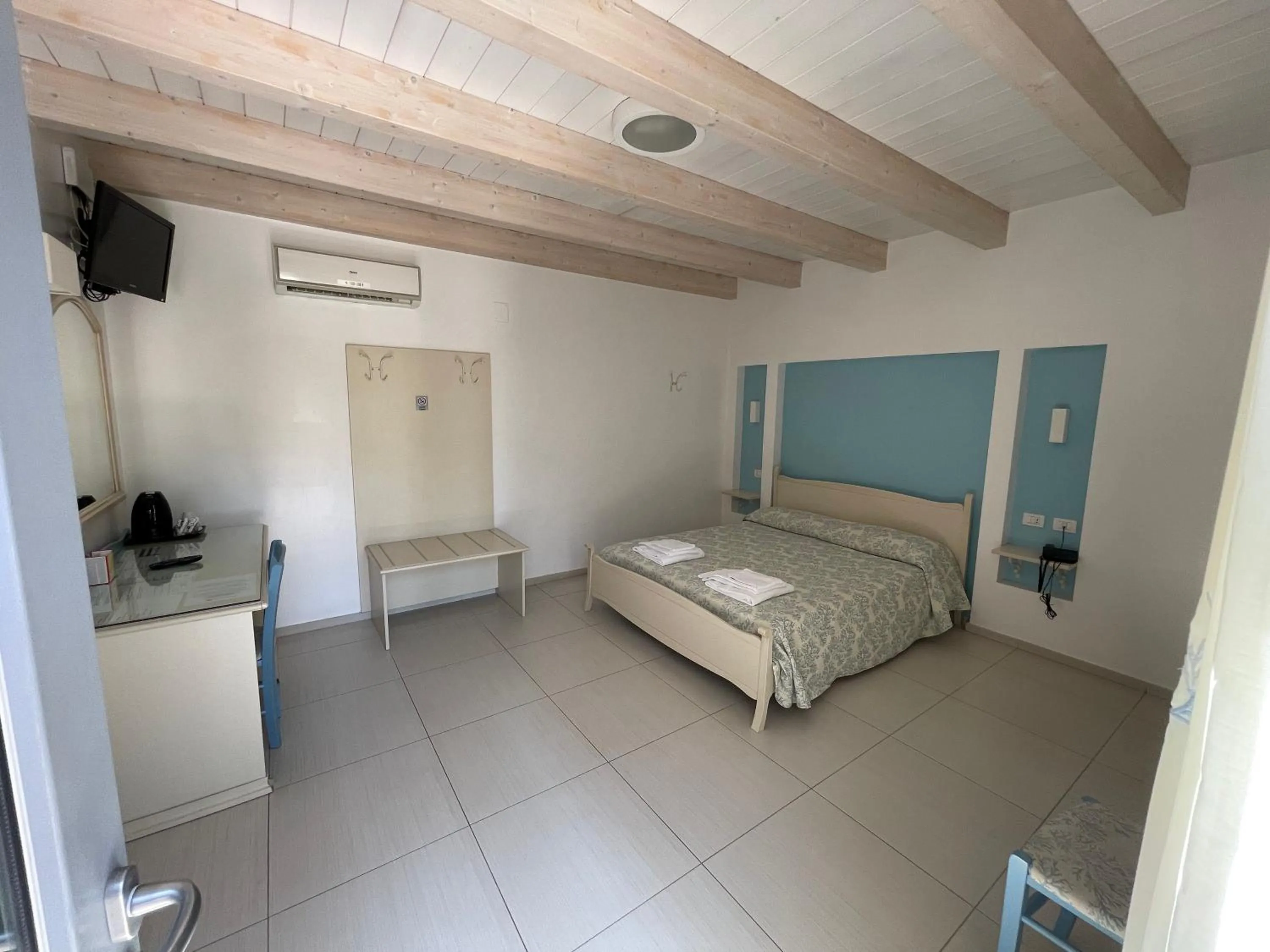 Bed in Baia Sangiorgio Hotel & Beach Club