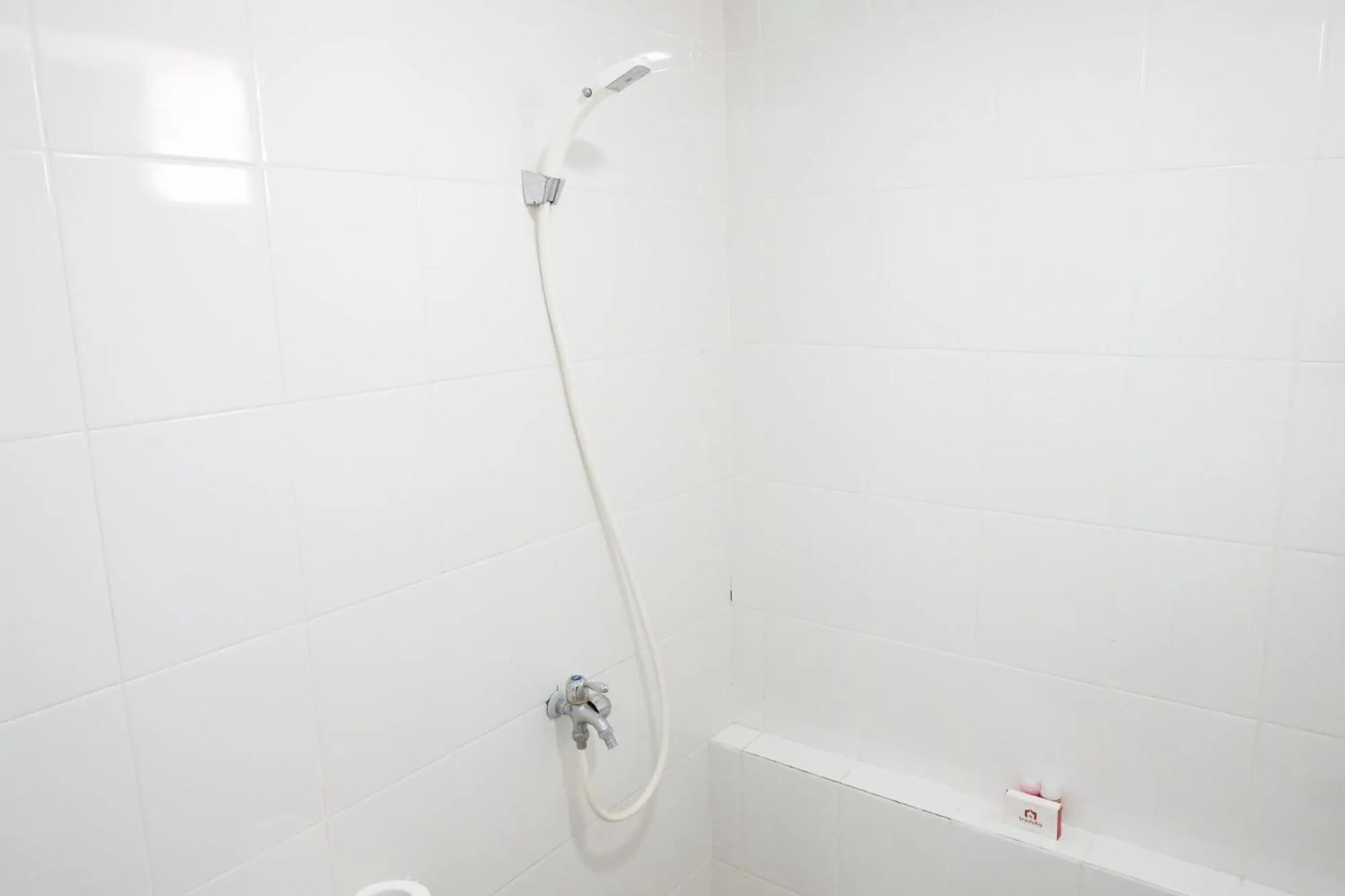 Shower in Exquisite 2BR Bassura City Apartment near Shopping Mall By Travelio