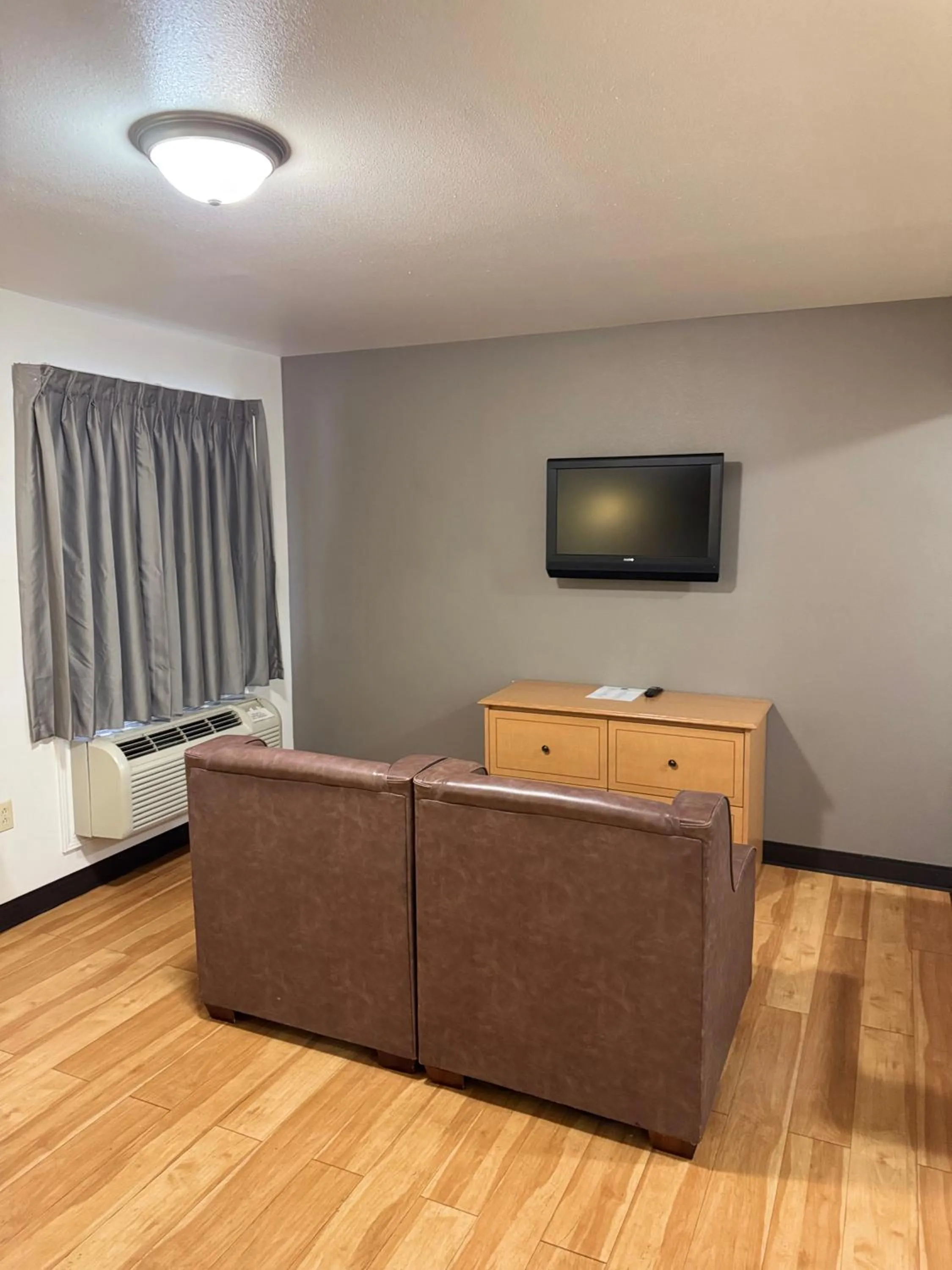 Seating area, Bed in Blue Bonnet Suites -Lubbock, TX - Medical Center