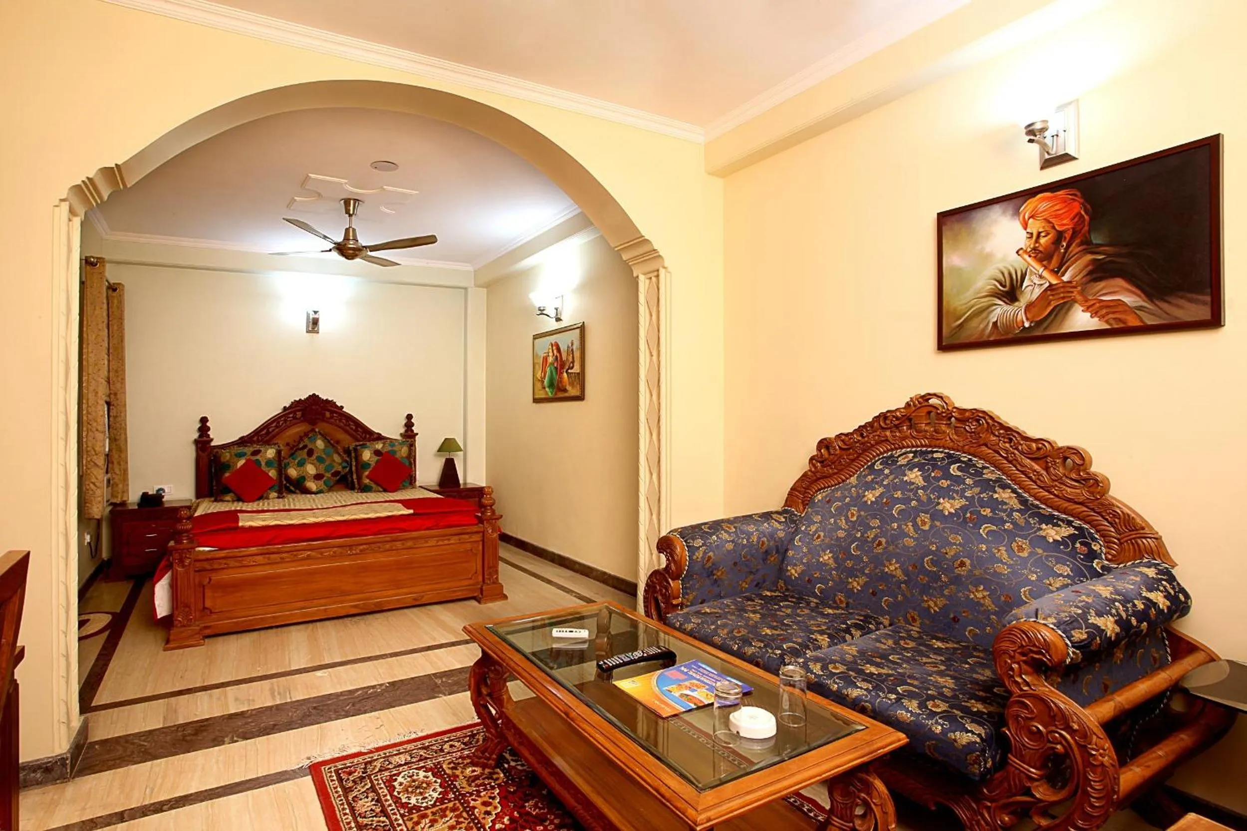 Living room, Bed in Indira International Inn