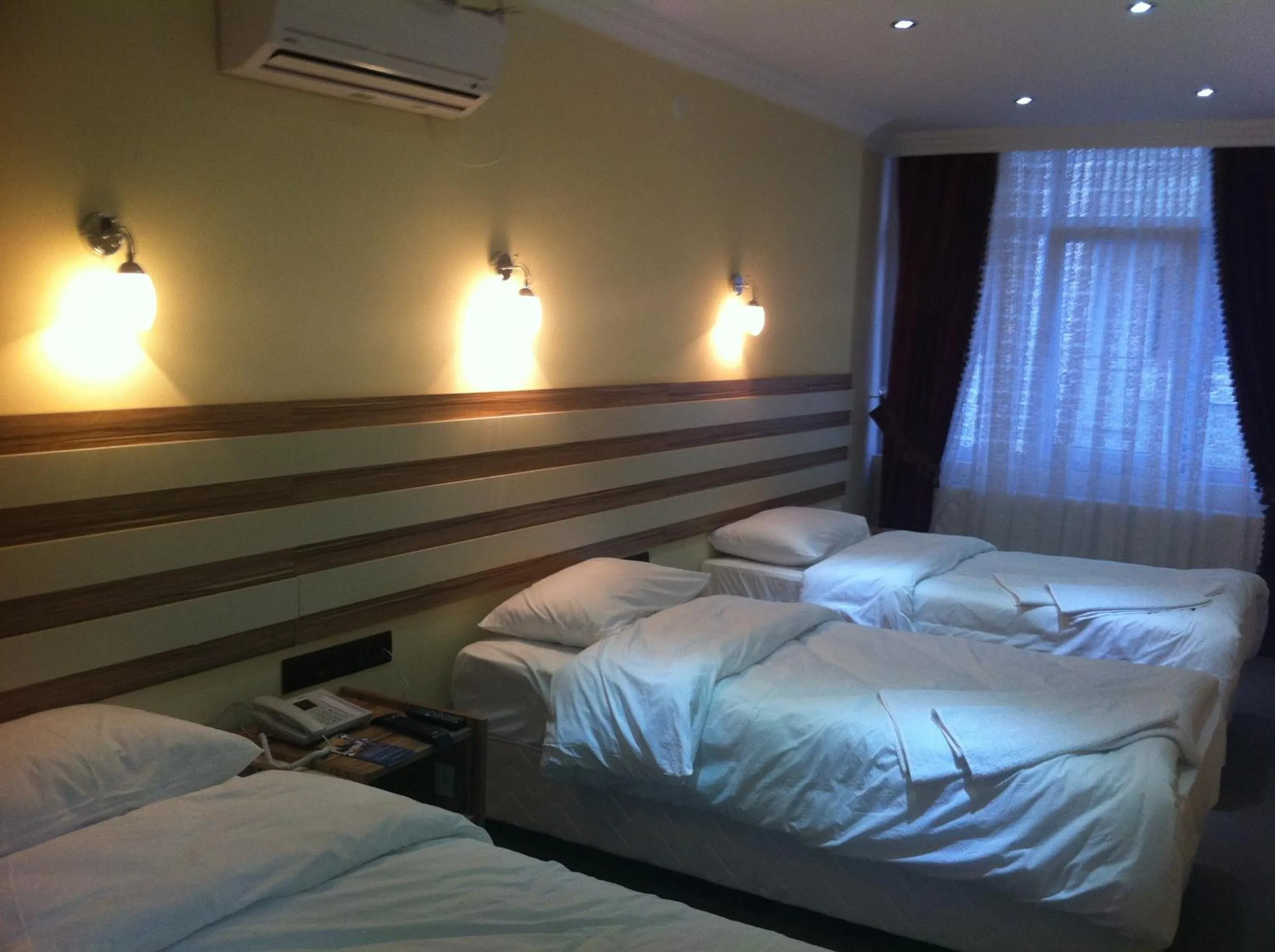 Photo of the whole room, Bed in TJ's Hotel