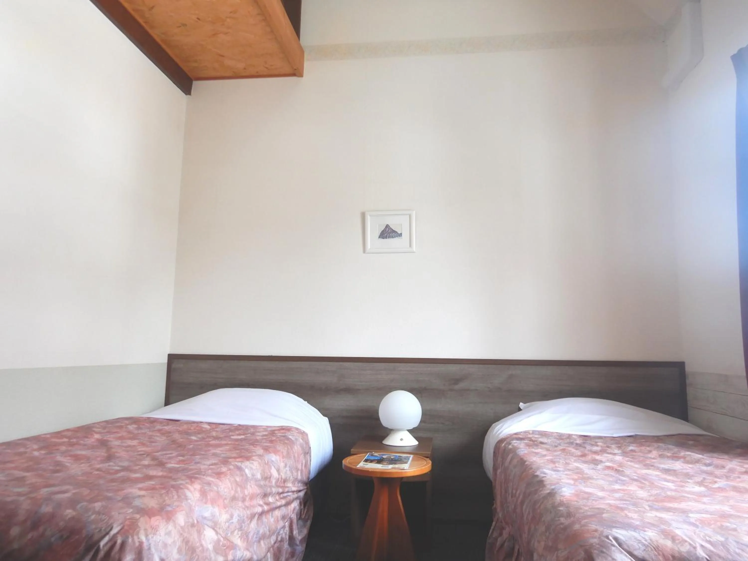 Bed in Petit Hotel Gracey Tomamu