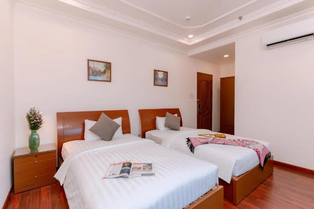 Bedroom, Bed in DAHLIALAND SAIGON HOTEL & SWIMMING PooL