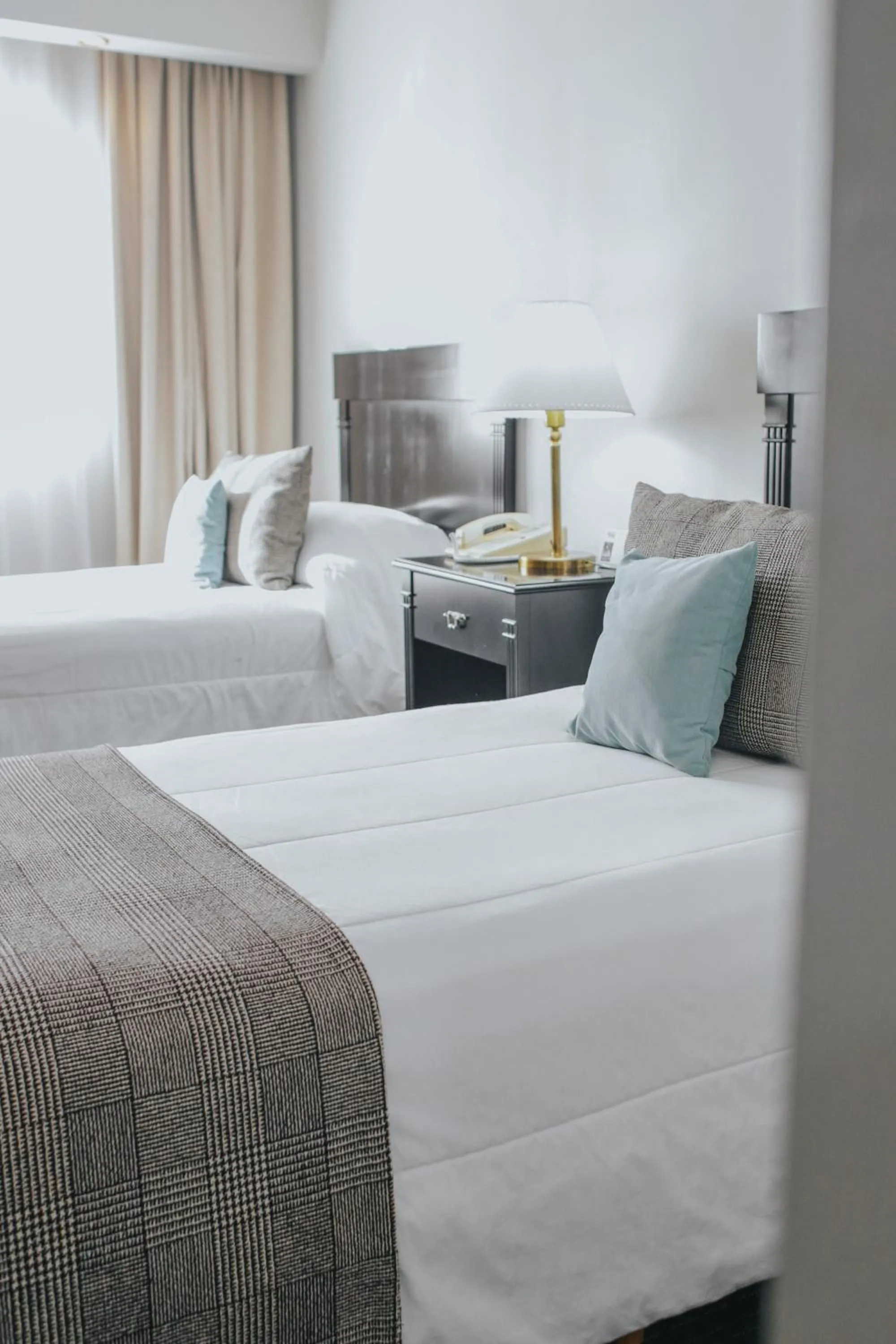 Bed in Plaza Real Suites Hotel