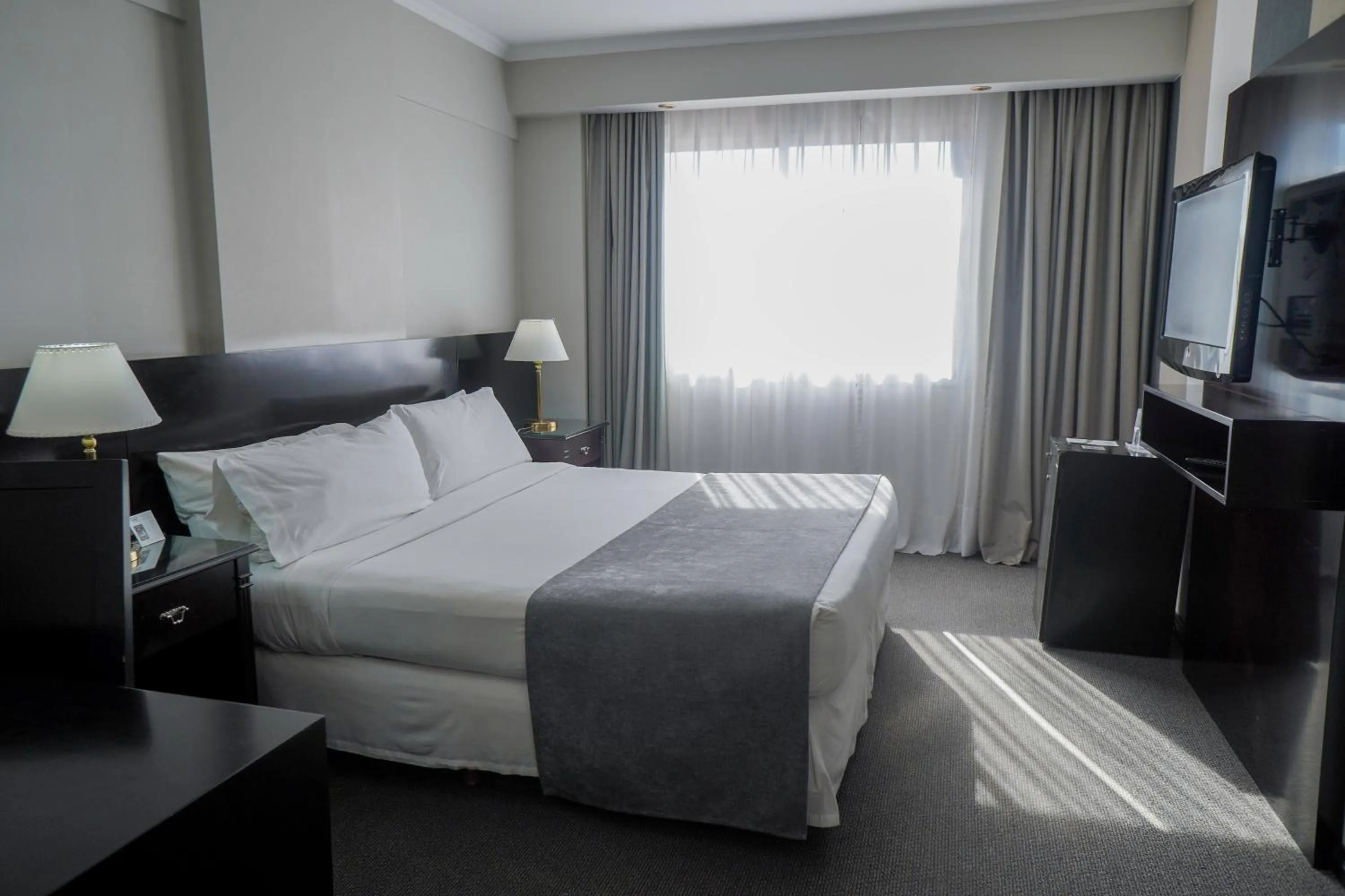 Bed in Plaza Real Suites Hotel