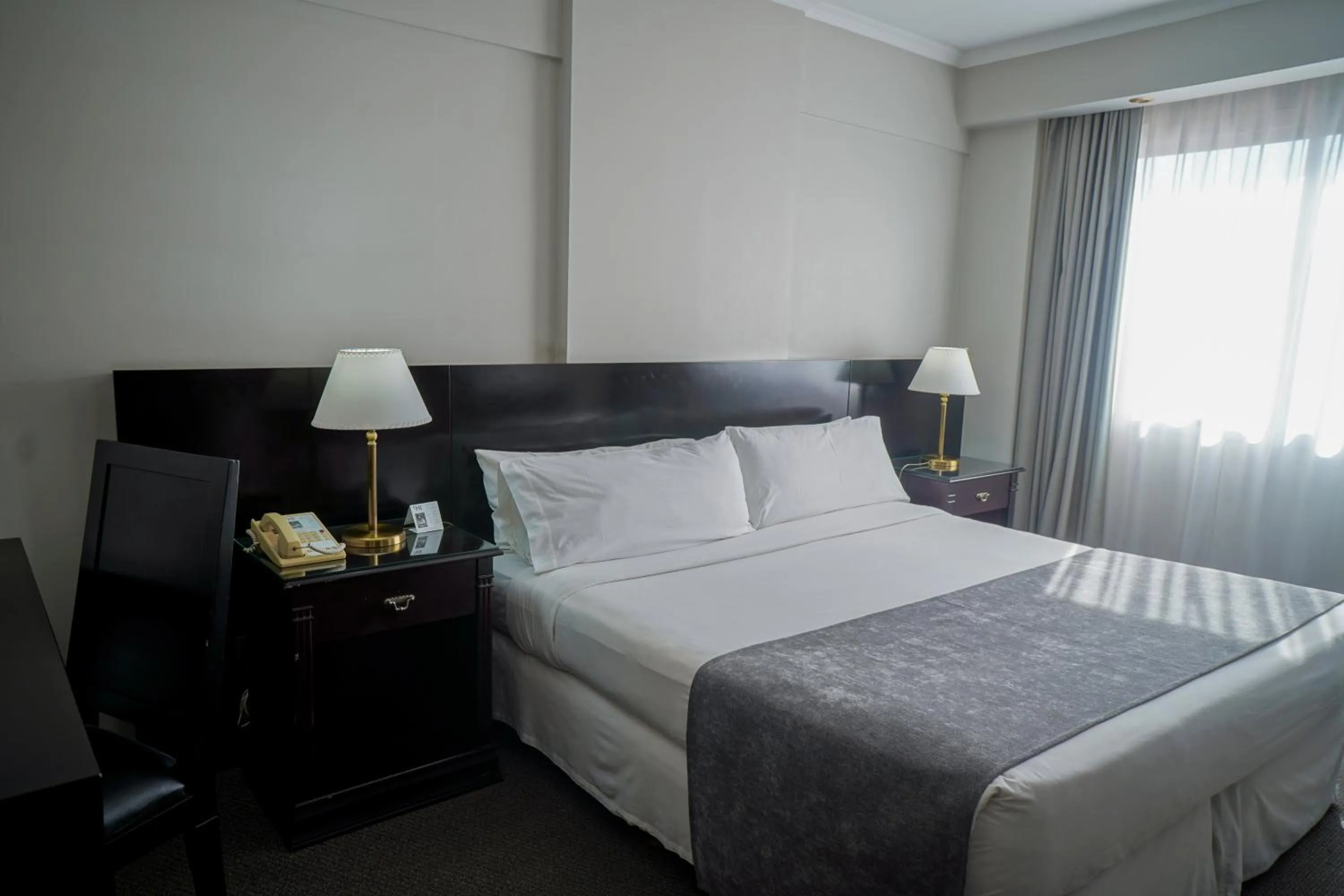 Bed in Plaza Real Suites Hotel