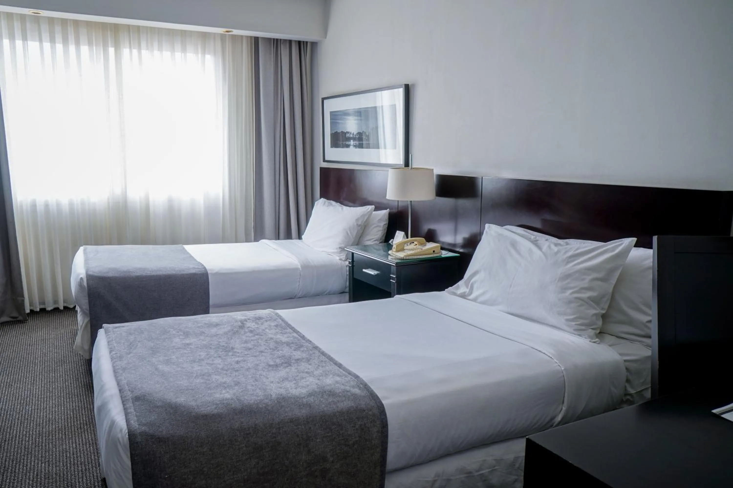 Bed in Plaza Real Suites Hotel