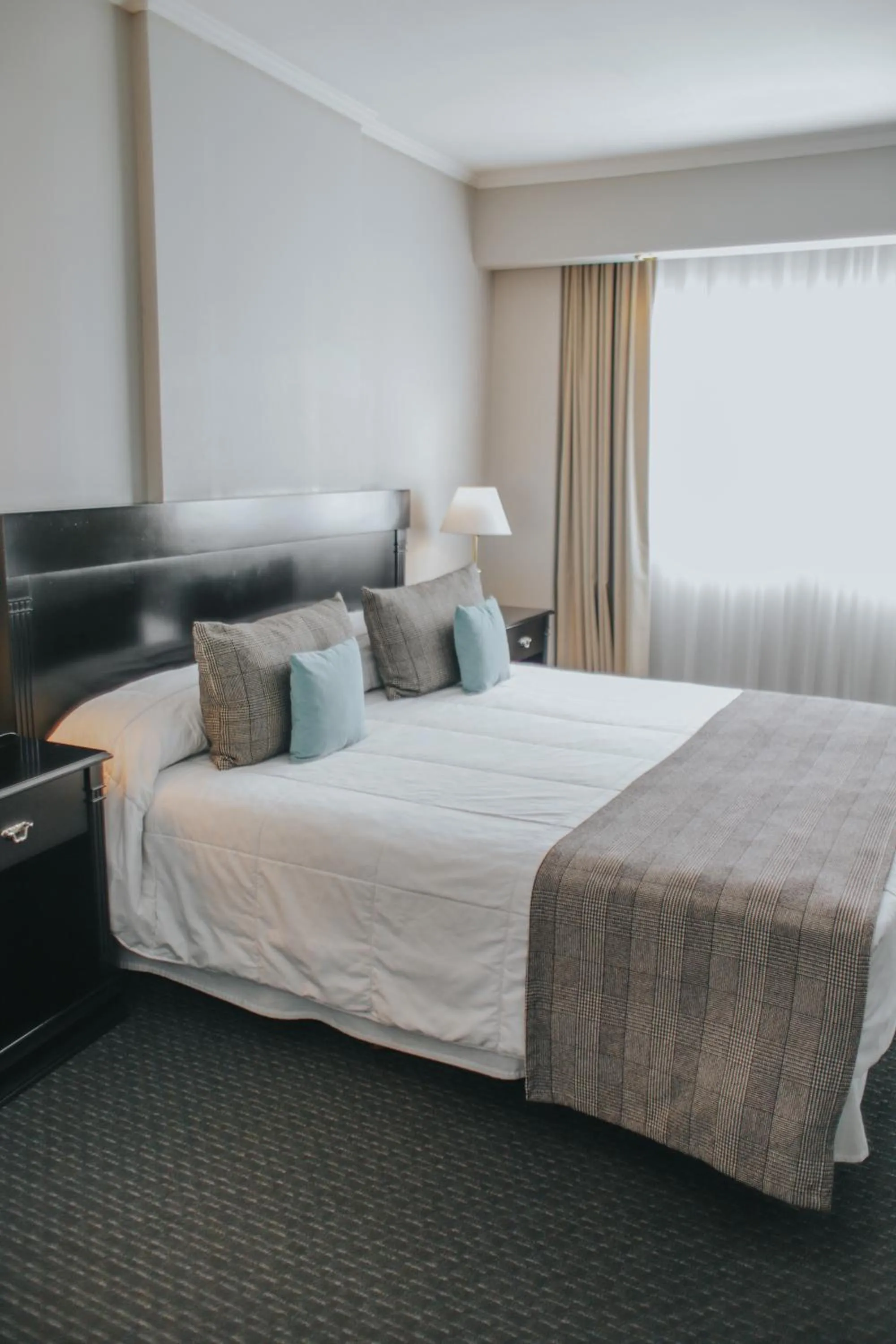 Bed in Plaza Real Suites Hotel