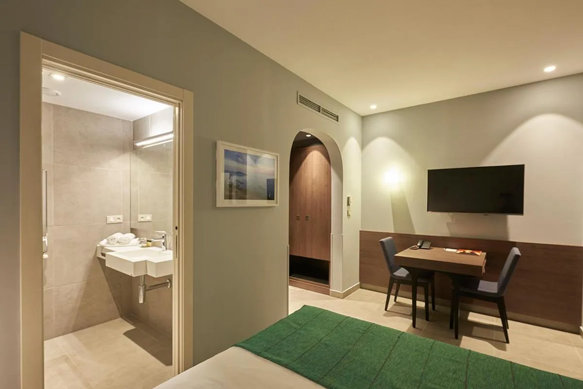 Bed in M Suite Hotel