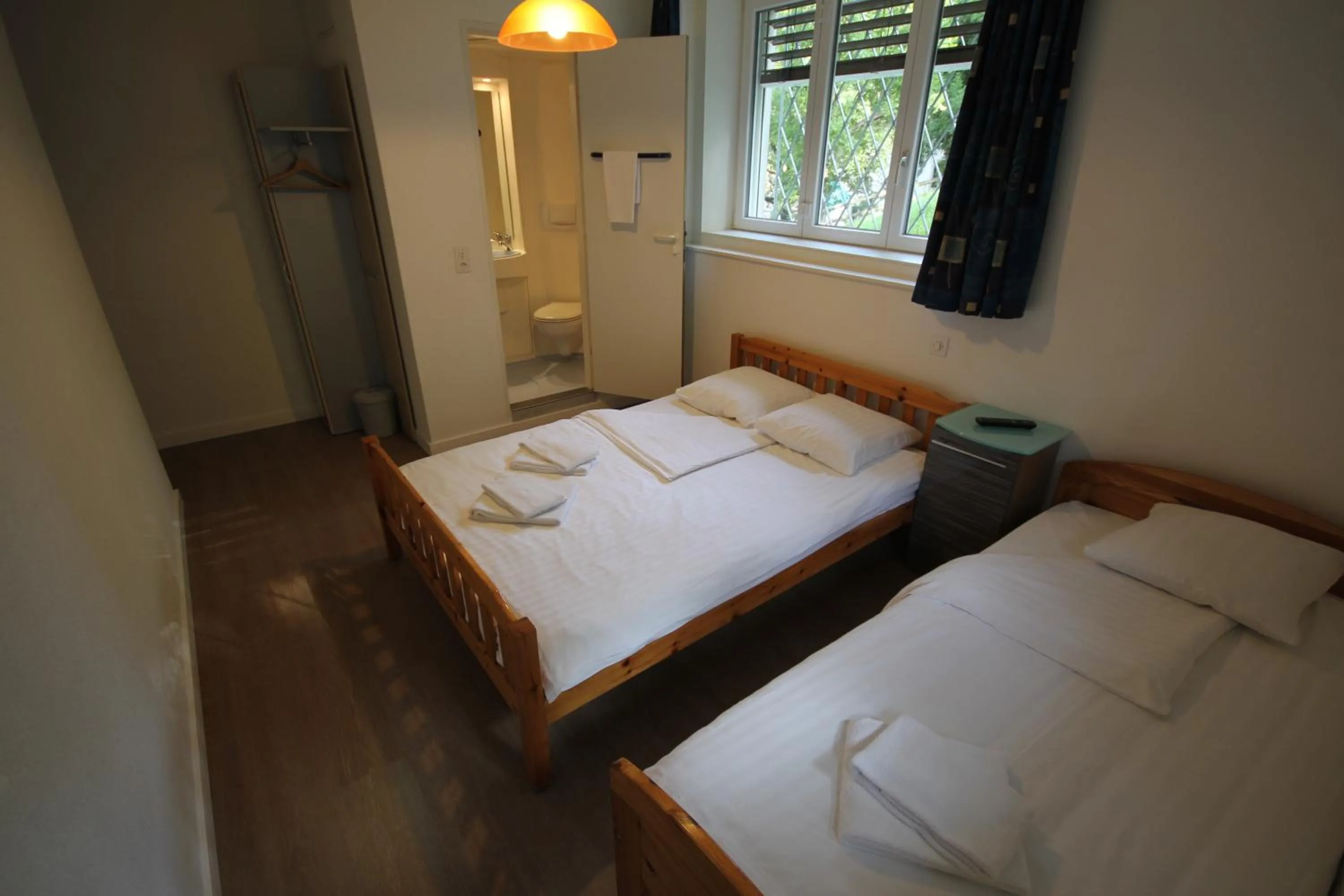 Toilet, Bed in Hotel Abaca