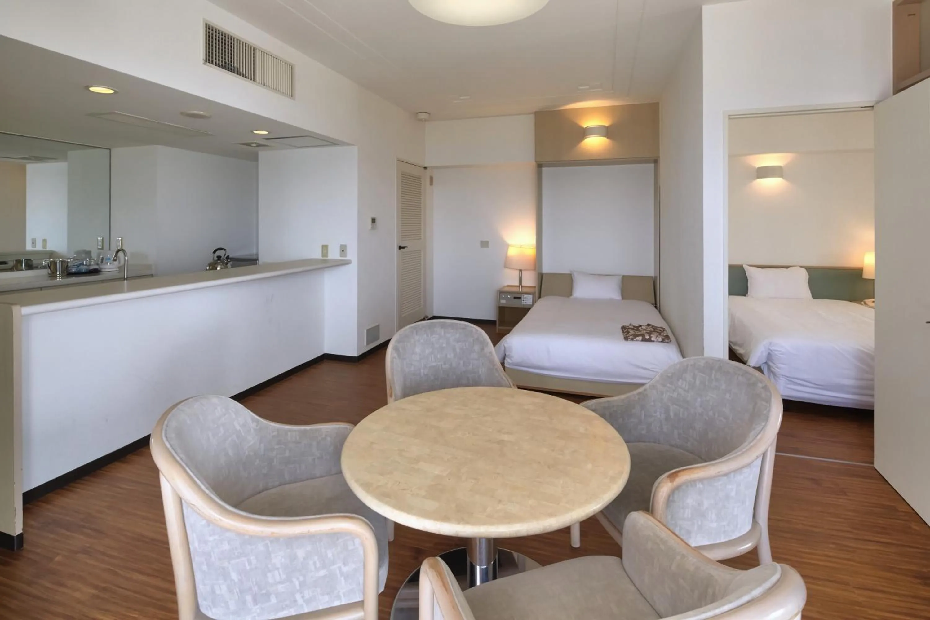 Kitchen or kitchenette, Bed in Hotel Mahaina Wellness Resorts Okinawa