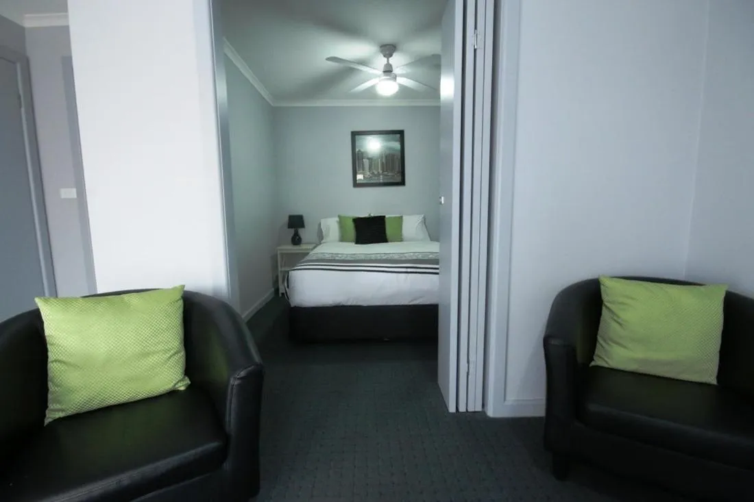 Bed in Golden Palms Motel