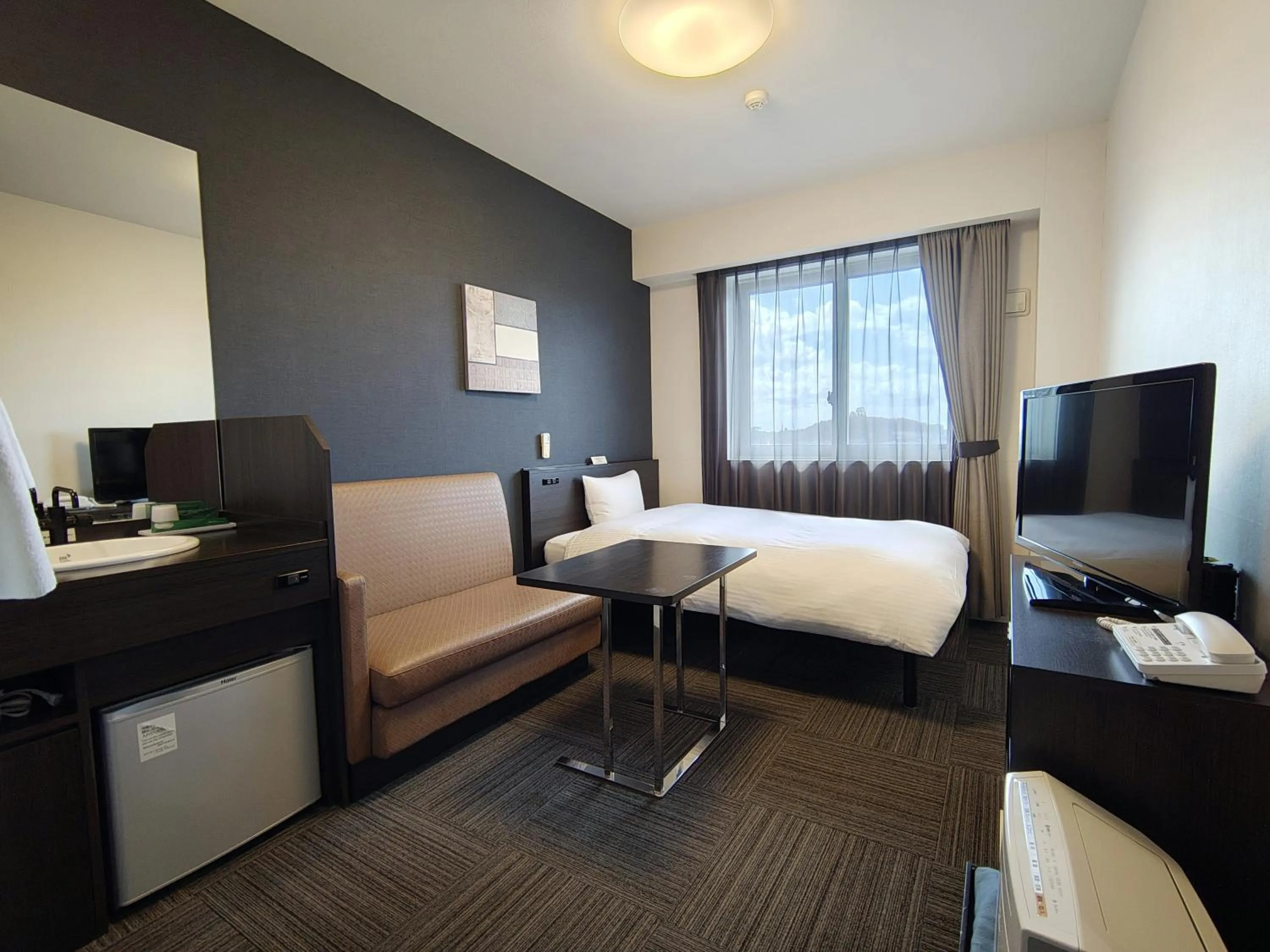 Photo of the whole room, Bed in Hotel Route-Inn Iwakiizumi Ekimae