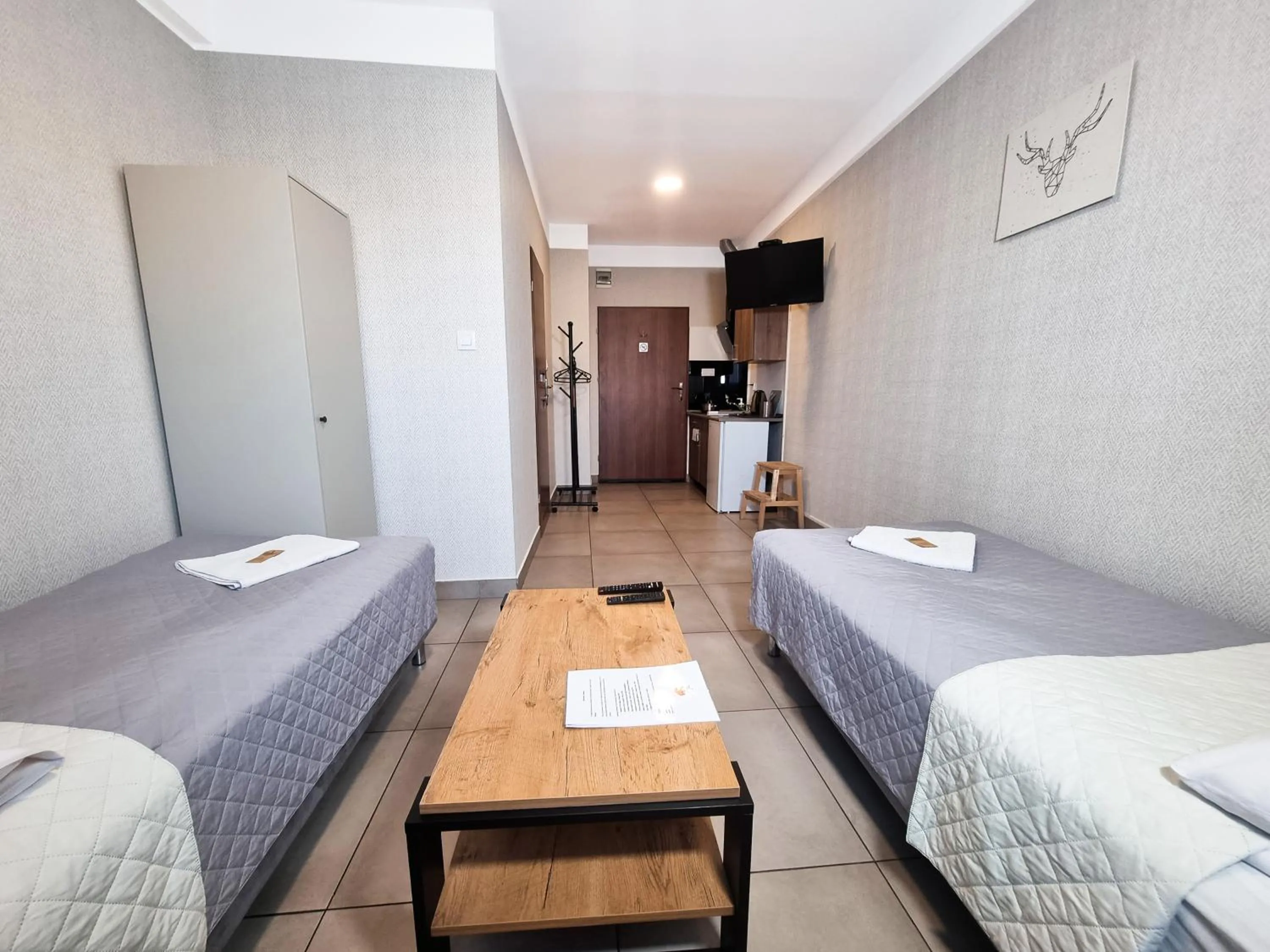 Communal lounge/ TV room, Bed in Orange Tree Hotel