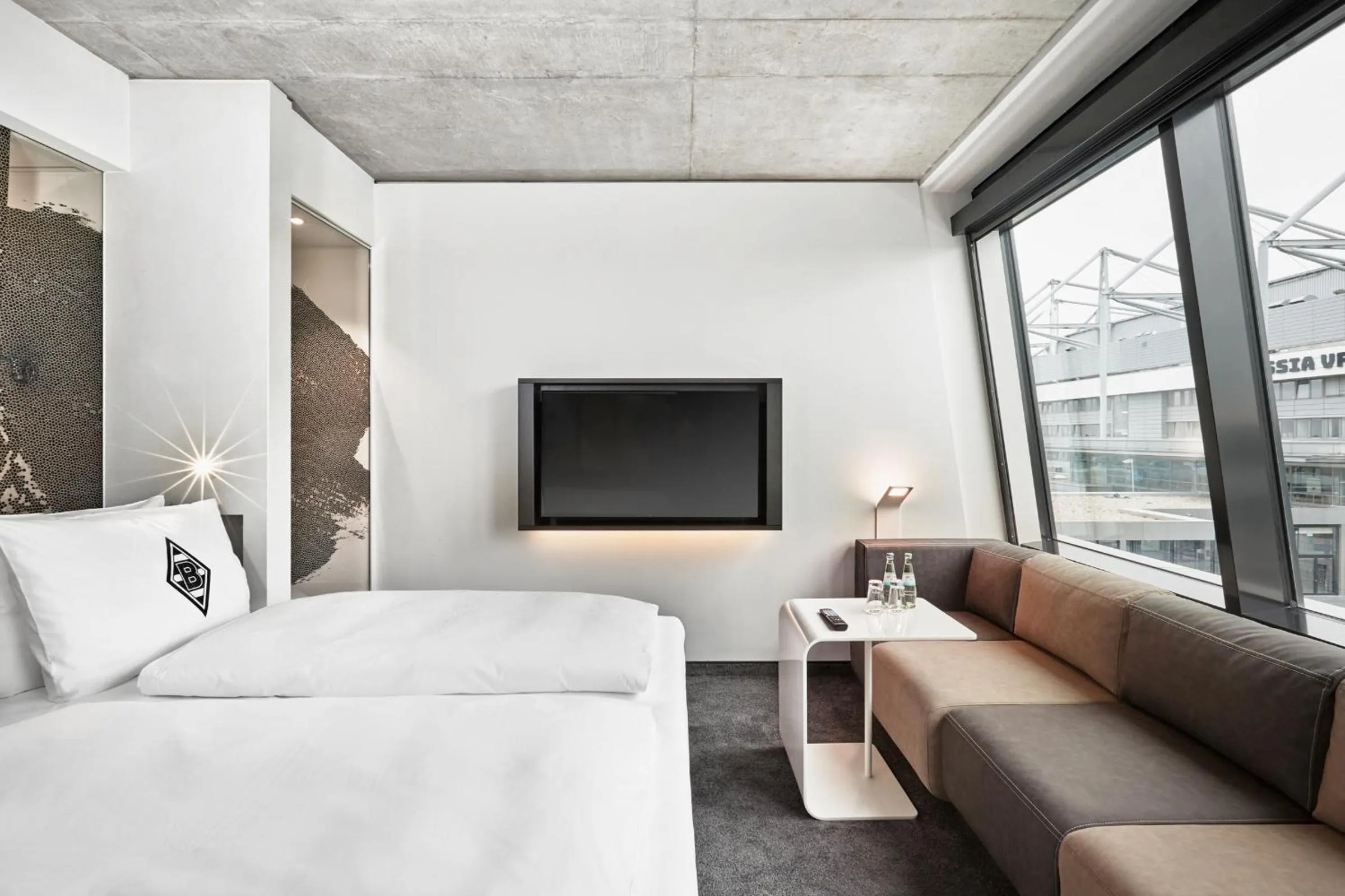 Photo of the whole room, Bed in H4 Hotel Mönchengladbach im BORUSSIA-PARK