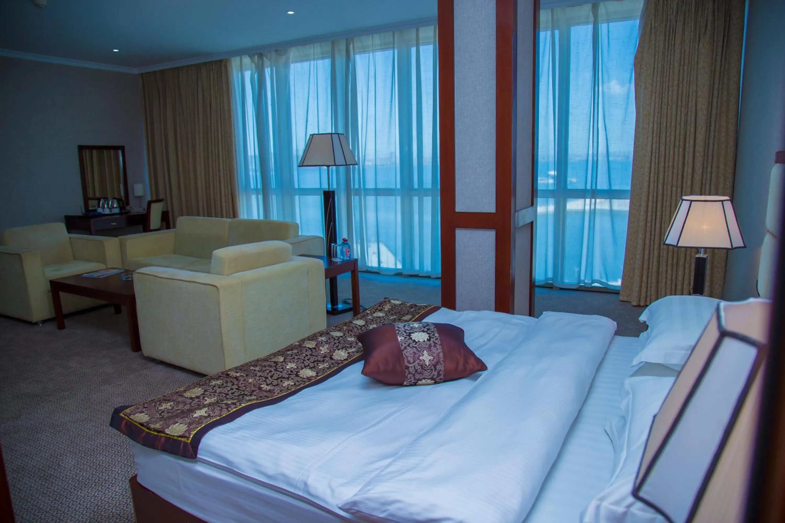 Living room, Bed in Golden Coast Hotel