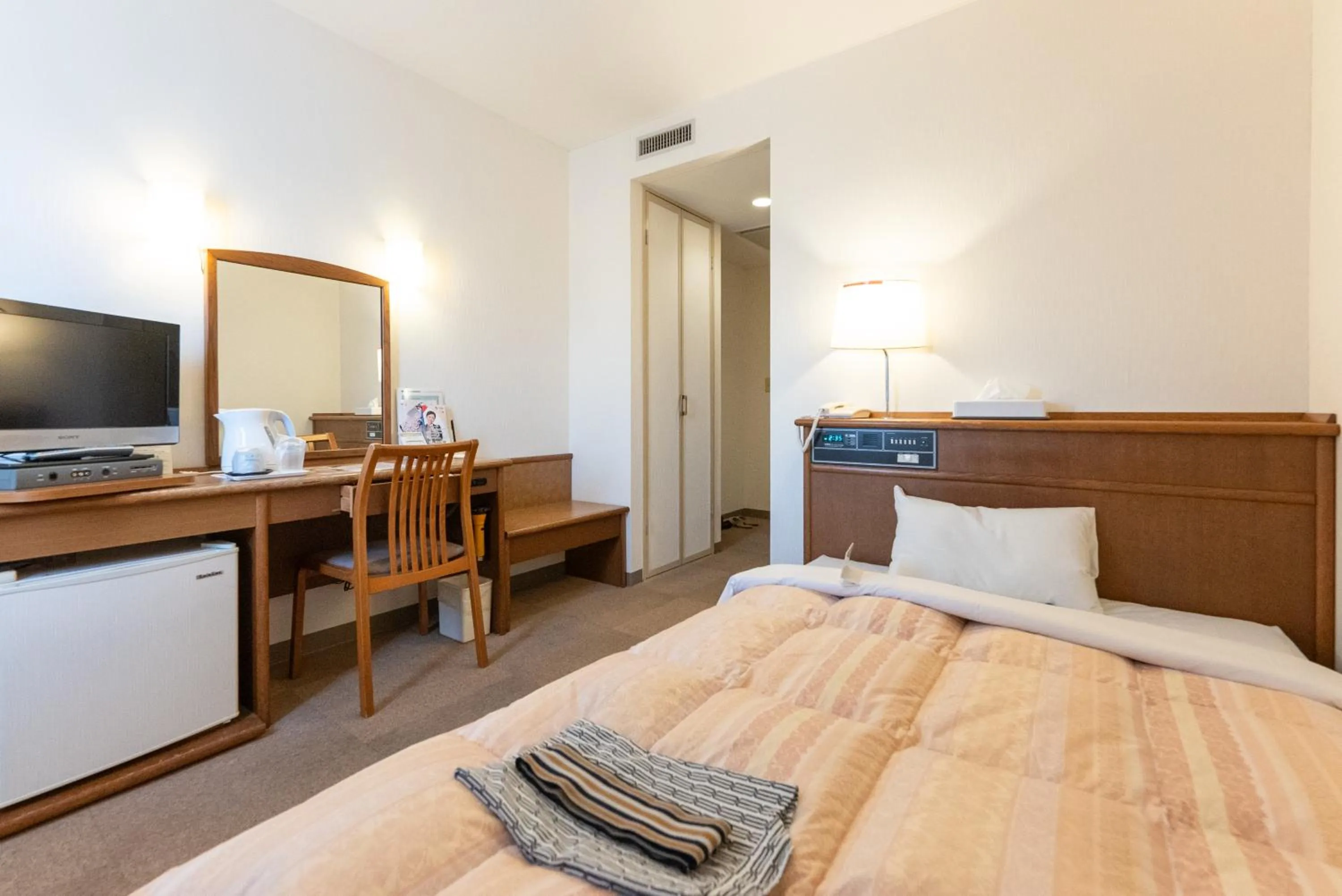 Bed in Tendo Central Hotel