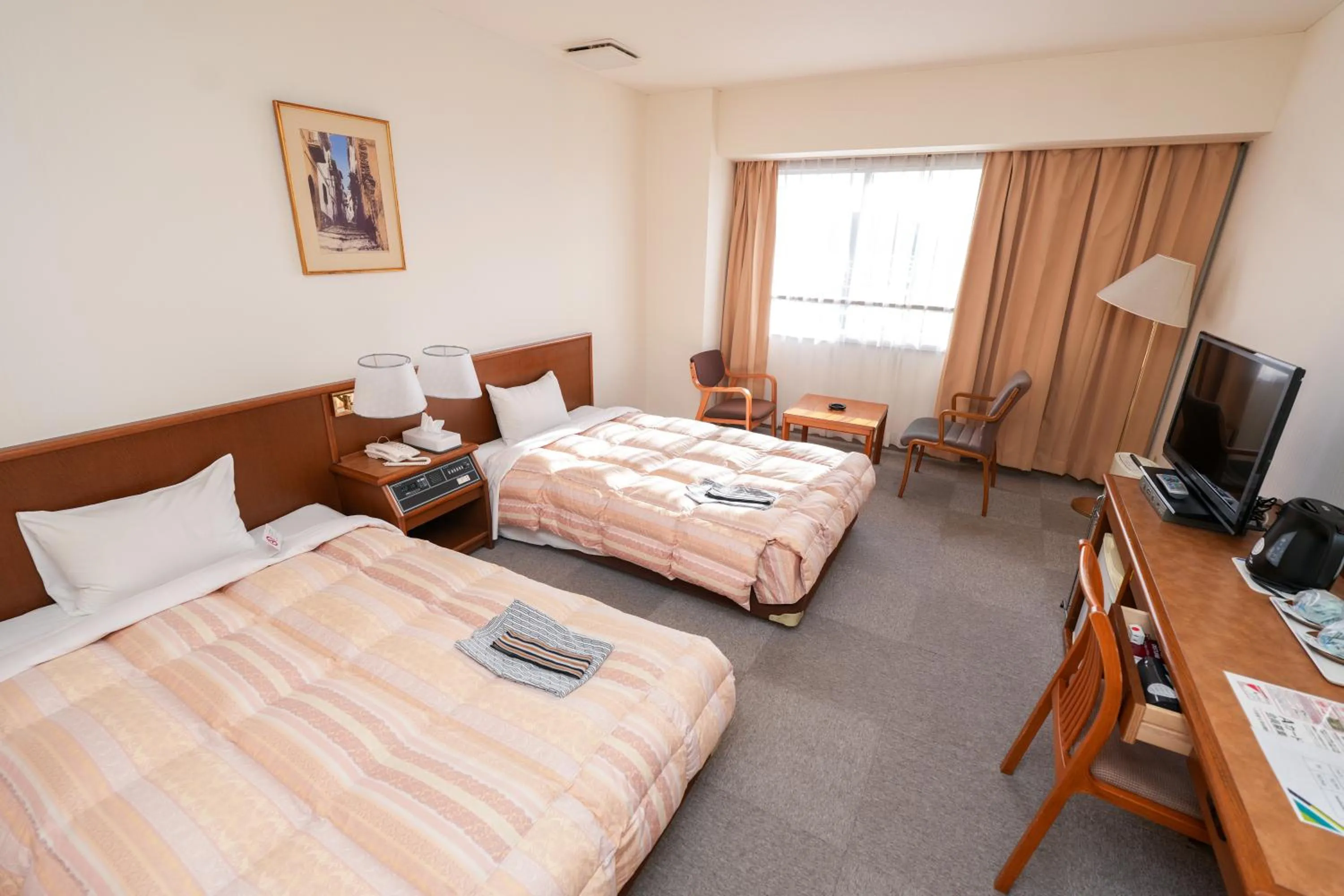 Bed in Tendo Central Hotel