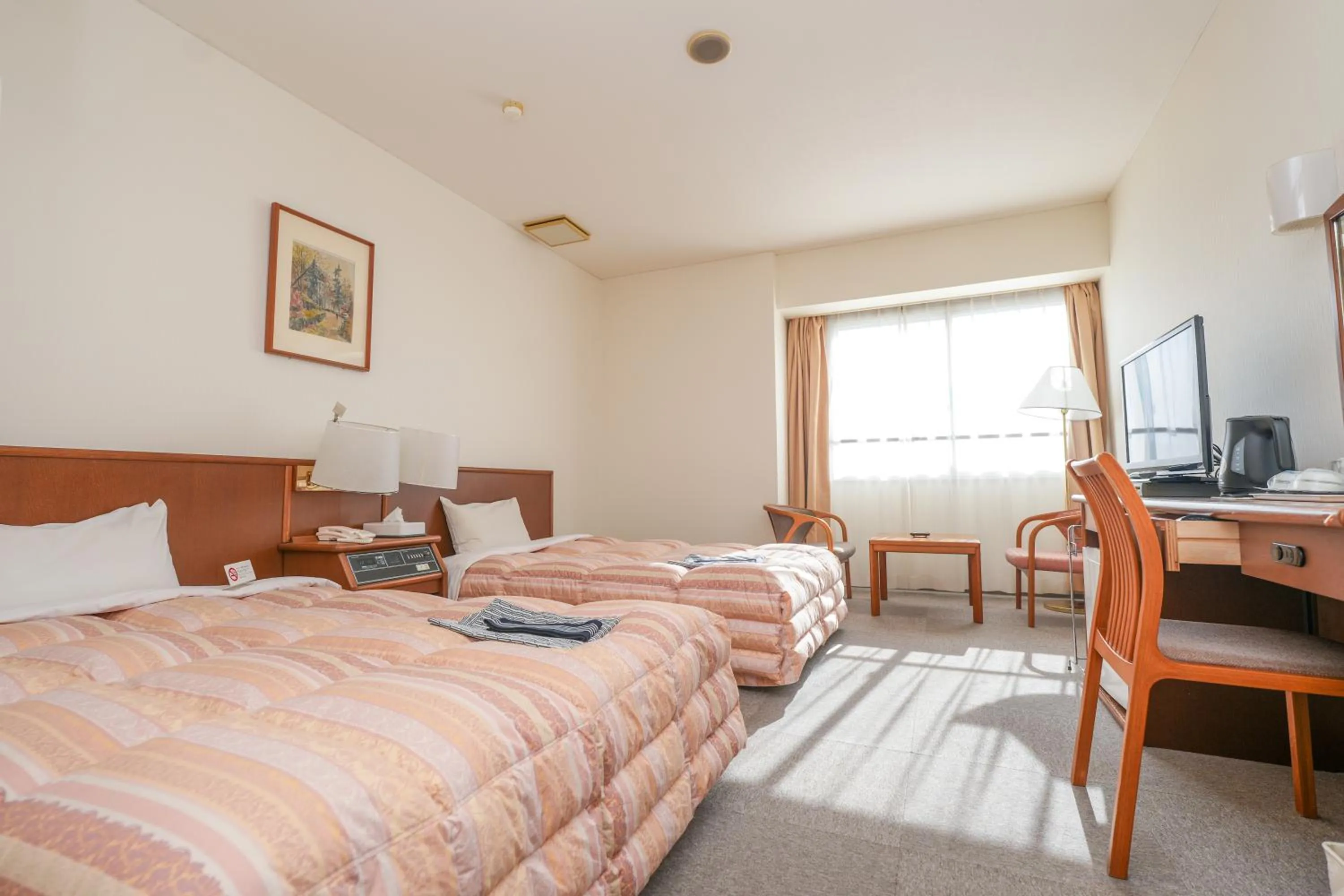 Bed in Tendo Central Hotel