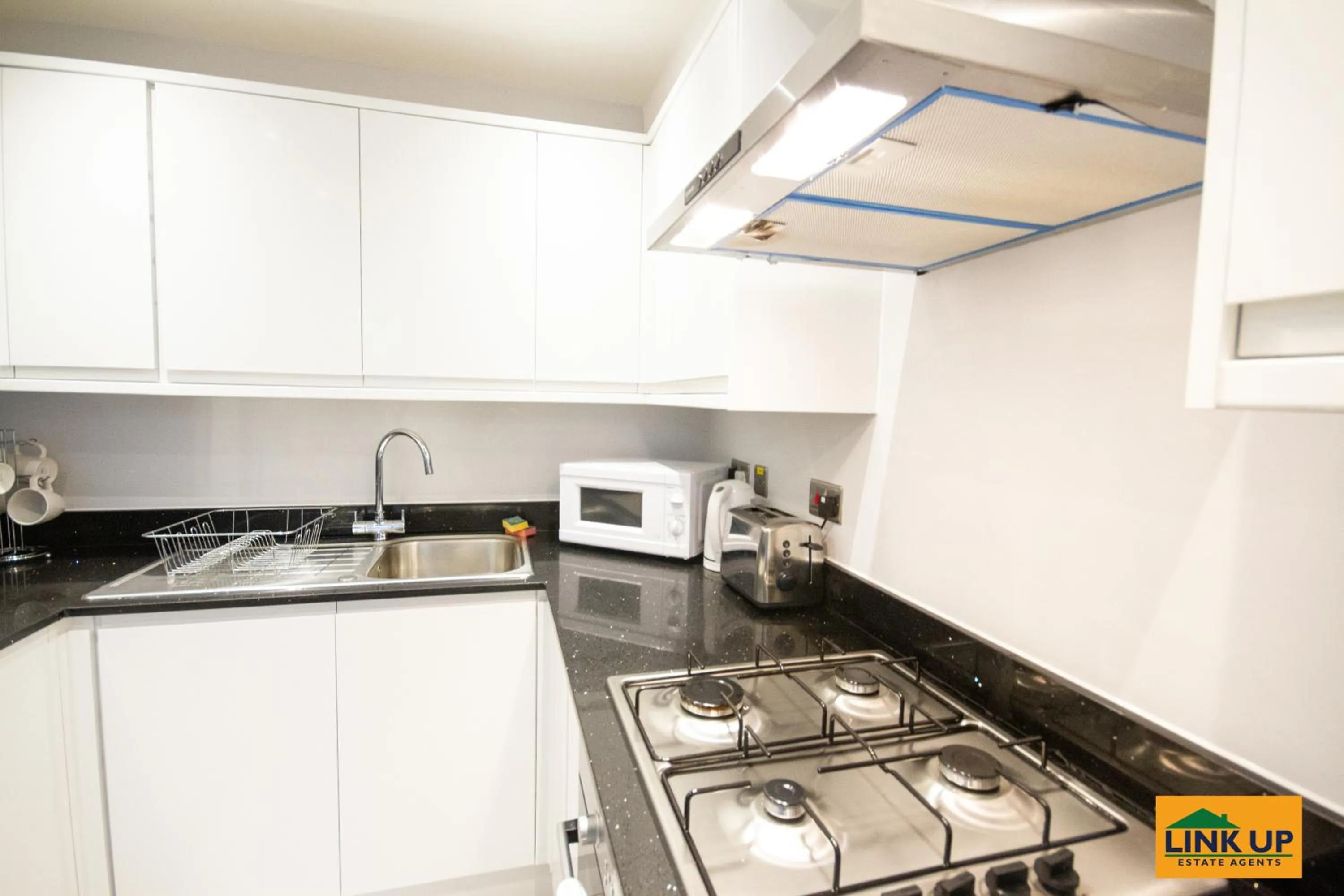 Kitchen or kitchenette in Holden Court Apartment - Apt 1