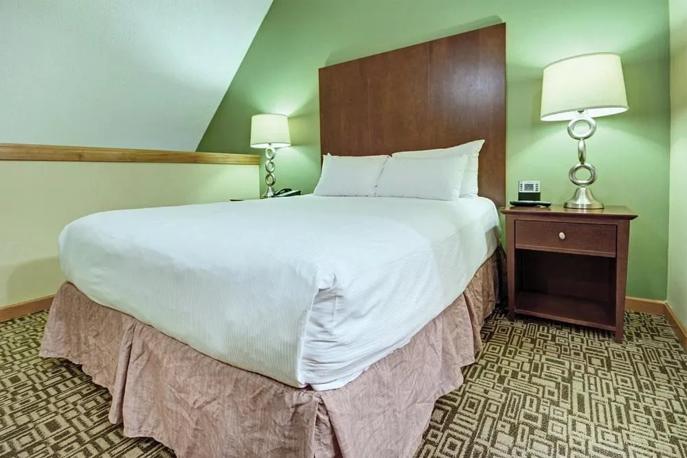Bed in Mountain Side Hotel Whistler by Executive