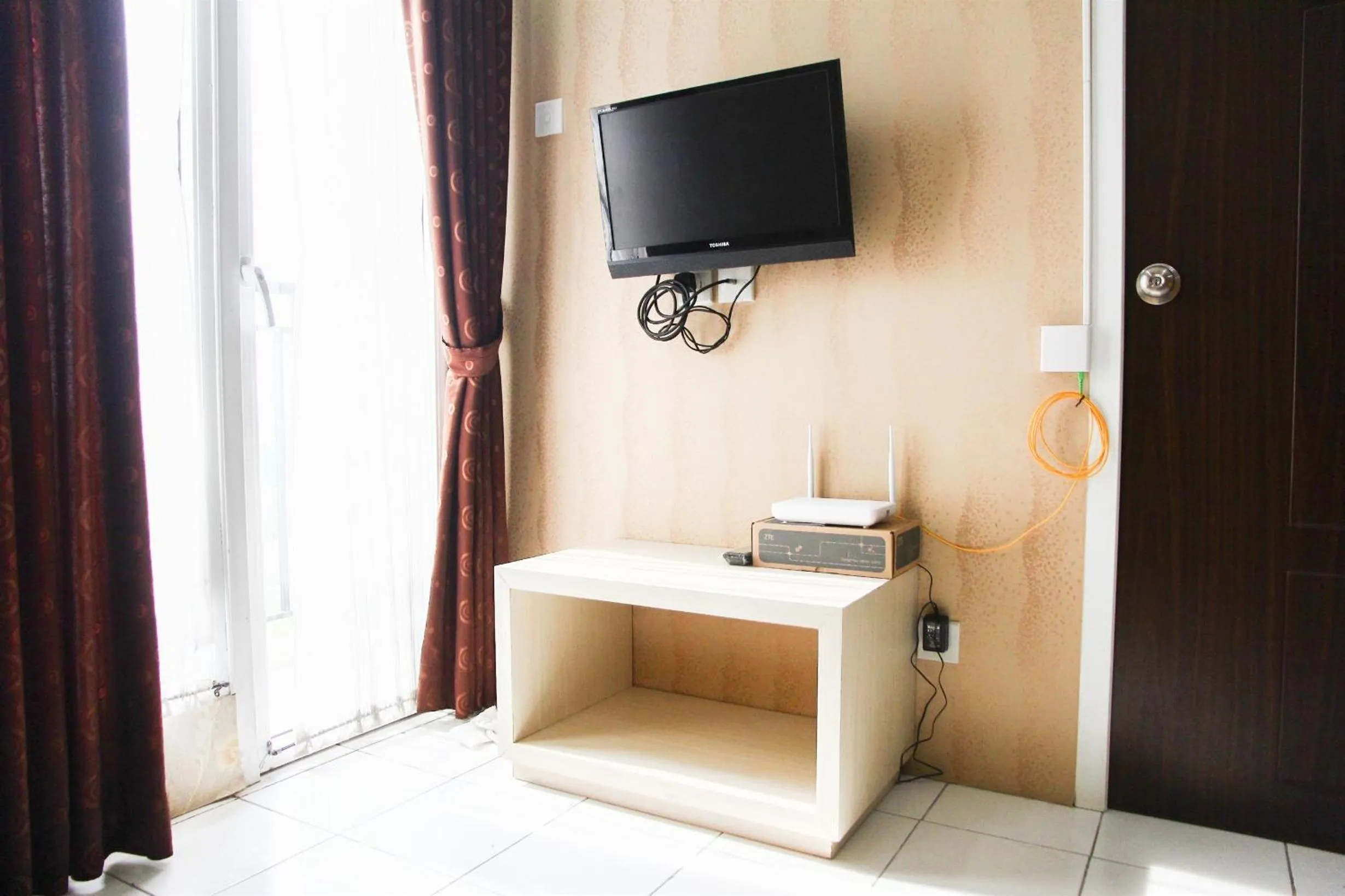 Living room in Pool View 2BR Mutiara Bekasi Apartment By Travelio