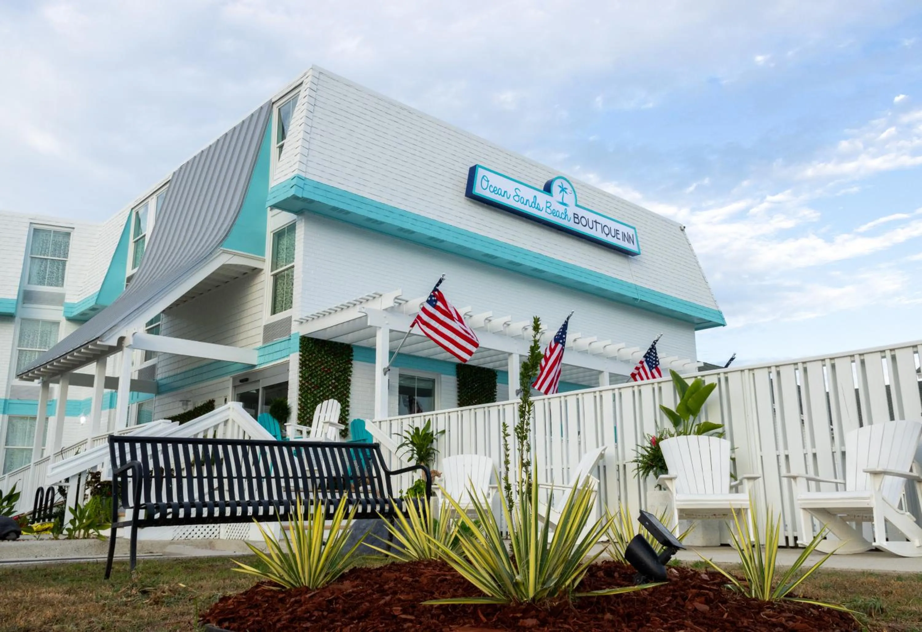 Property building in NEW 2026-Ocean Sands Beach Boutique Inn-Sauna and Salt-Mineral Pool -Free Beach Bikes and Famous Beach- Fresh Baked Cookies and Popcorn - Bathrobes and Sunscreen in all rooms-Ultra Sparkling-Free Laundry- 4 Grand Black Beds-Call NOW & Save-1-252-AHA-SAND