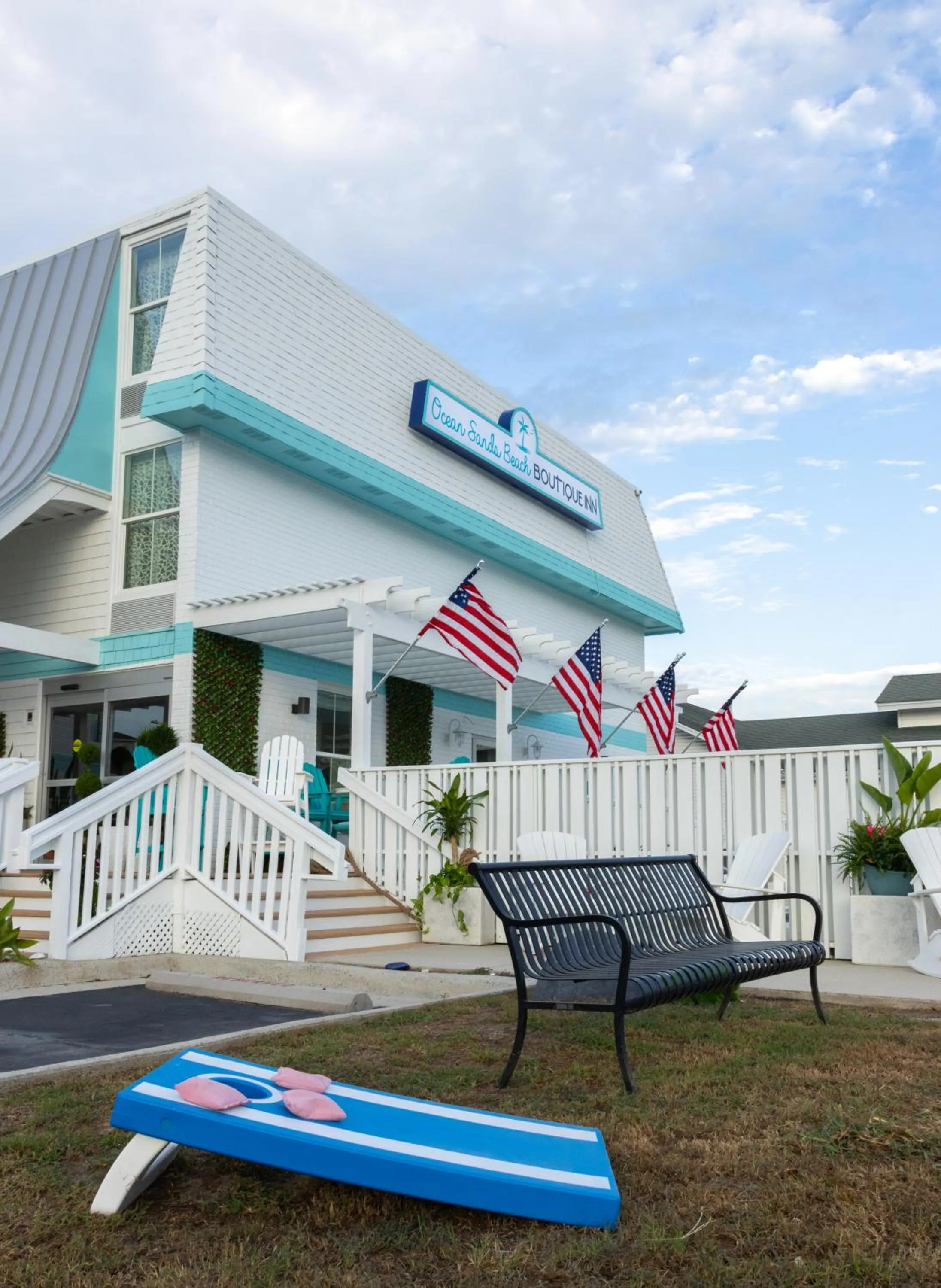 Property building in NEW 2026-Ocean Sands Beach Boutique Inn-Sauna and Salt-Mineral Pool -Free Beach Bikes and Famous Beach- Fresh Baked Cookies and Popcorn - Bathrobes and Sunscreen in all rooms-Ultra Sparkling-Free Laundry- 4 Grand Black Beds-Call NOW & Save-1-252-AHA-SAND