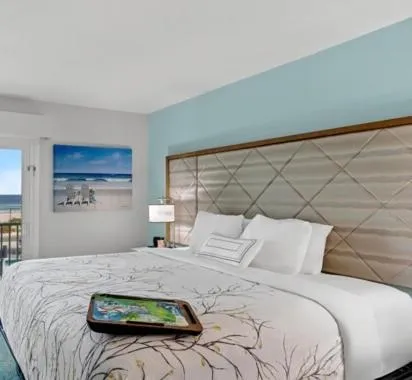 Bed in NEW 2026-Ocean Sands Beach Boutique Inn-Sauna and Salt-Mineral Pool -Free Beach Bikes and Famous Beach- Fresh Baked Cookies and Popcorn - Bathrobes and Sunscreen in all rooms-Ultra Sparkling-Free Laundry- 4 Grand Black Beds-Call NOW & Save-1-252-AHA-SAND