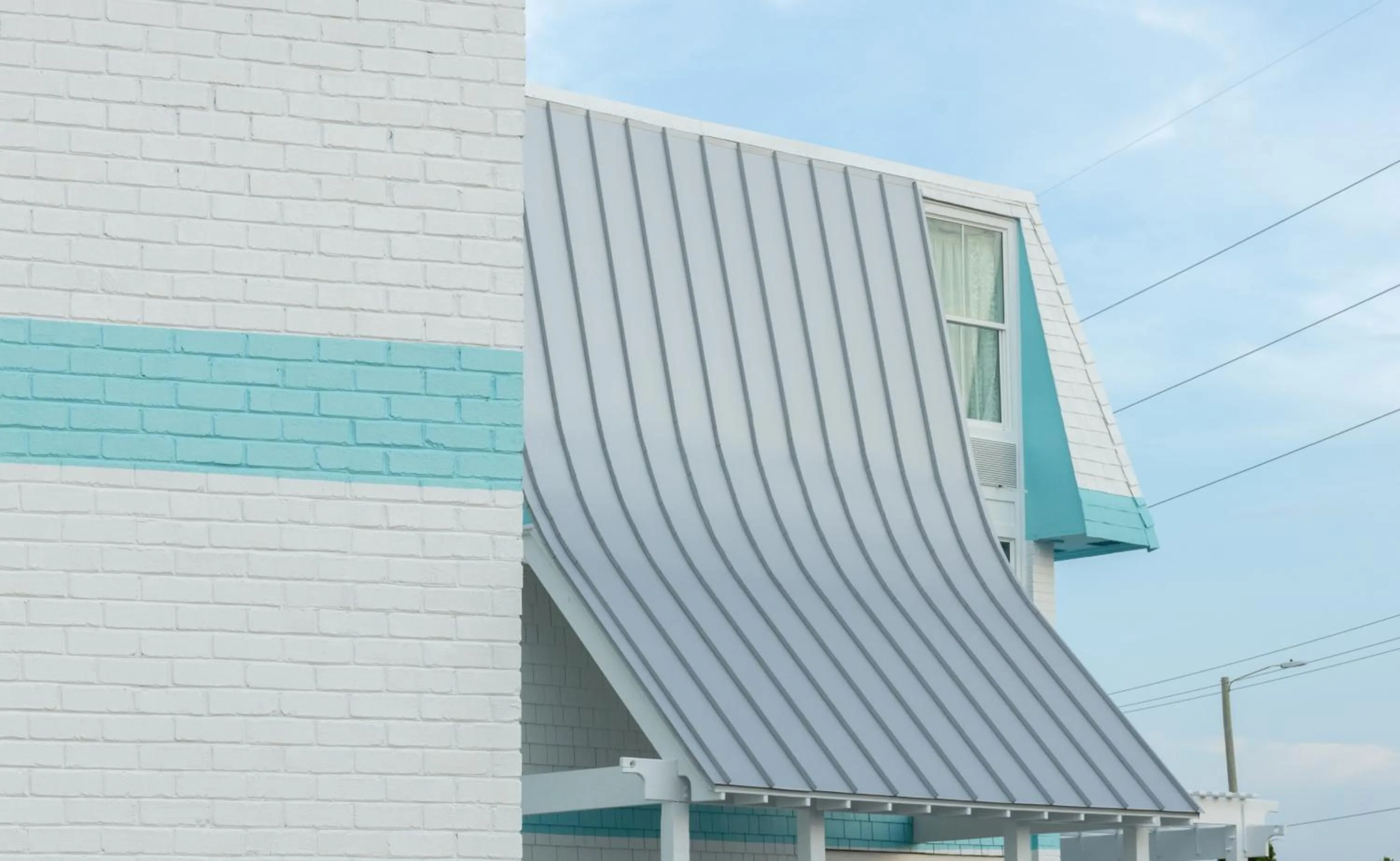 Property building in NEW 2026-Ocean Sands Beach Boutique Inn-Sauna and Salt-Mineral Pool -Free Beach Bikes and Famous Beach- Fresh Baked Cookies and Popcorn - Bathrobes and Sunscreen in all rooms-Ultra Sparkling-Free Laundry- 4 Grand Black Beds-Call NOW & Save-1-252-AHA-SAND