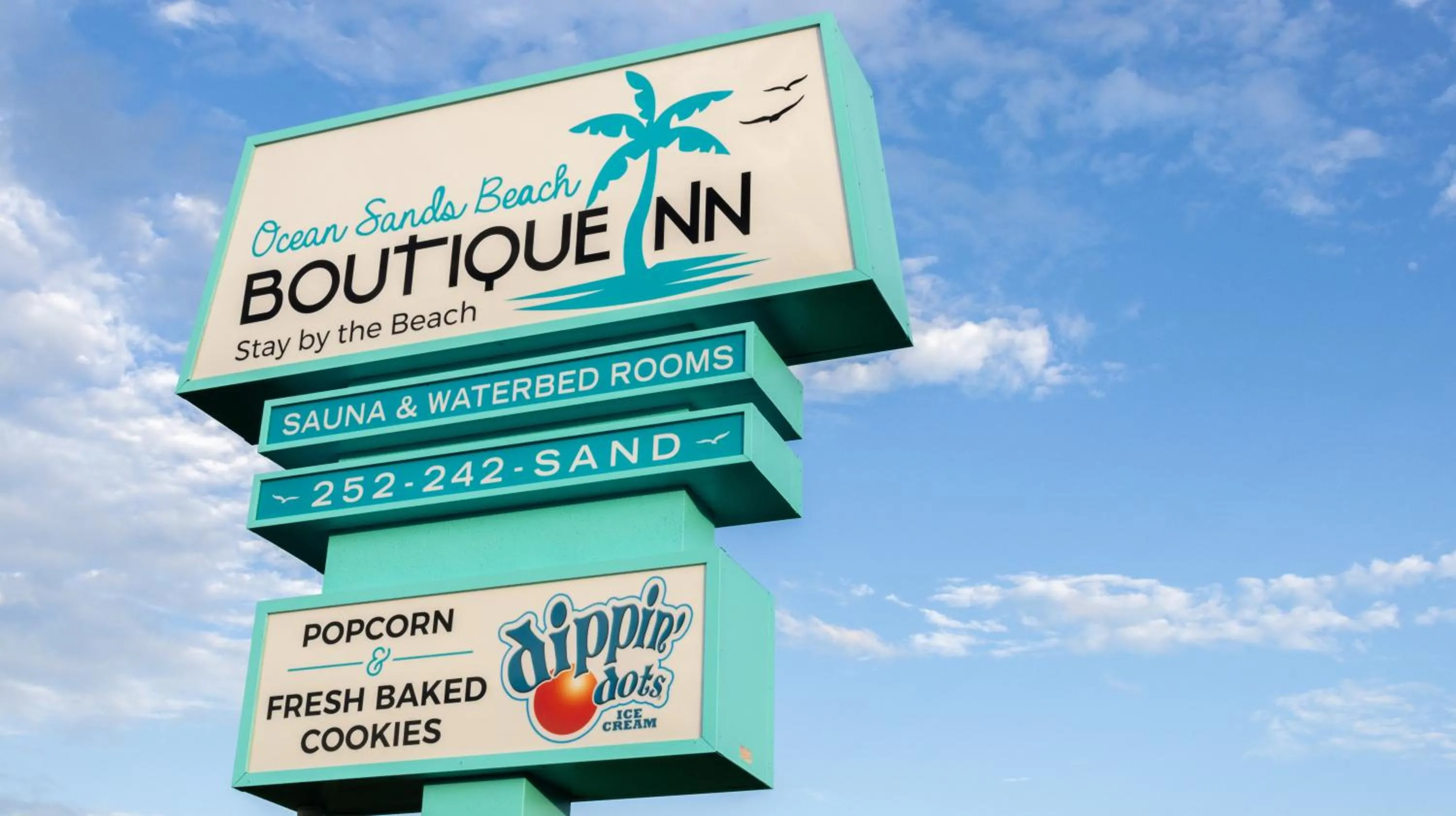 Property building in NEW 2026-Ocean Sands Beach Boutique Inn-Sauna and Salt-Mineral Pool -Free Beach Bikes and Famous Beach- Fresh Baked Cookies and Popcorn - Bathrobes and Sunscreen in all rooms-Ultra Sparkling-Free Laundry- 4 Grand Black Beds-Call NOW & Save-1-252-AHA-SAND