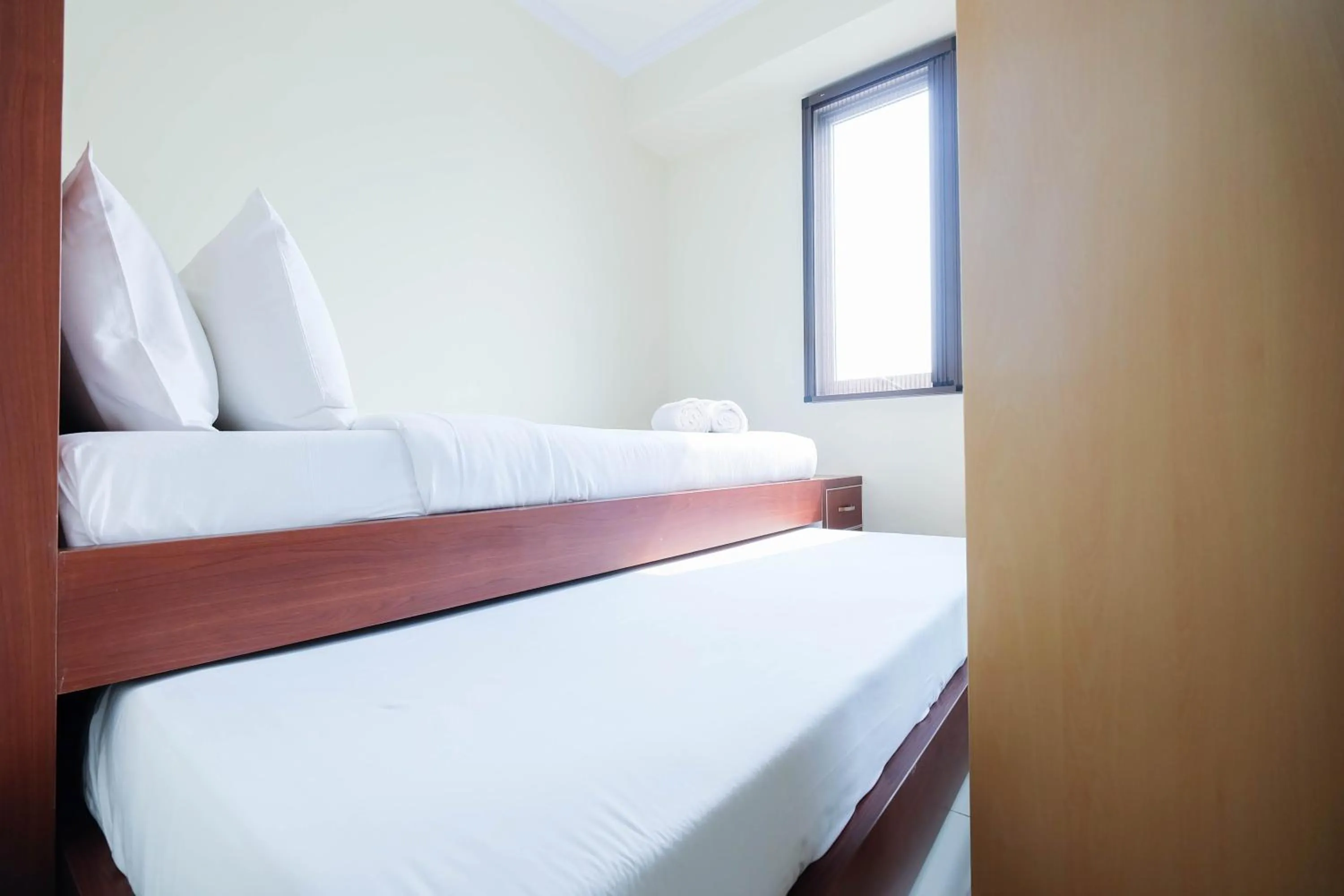 Bed in Cozy 2BR Bassura City Apartment By Travelio