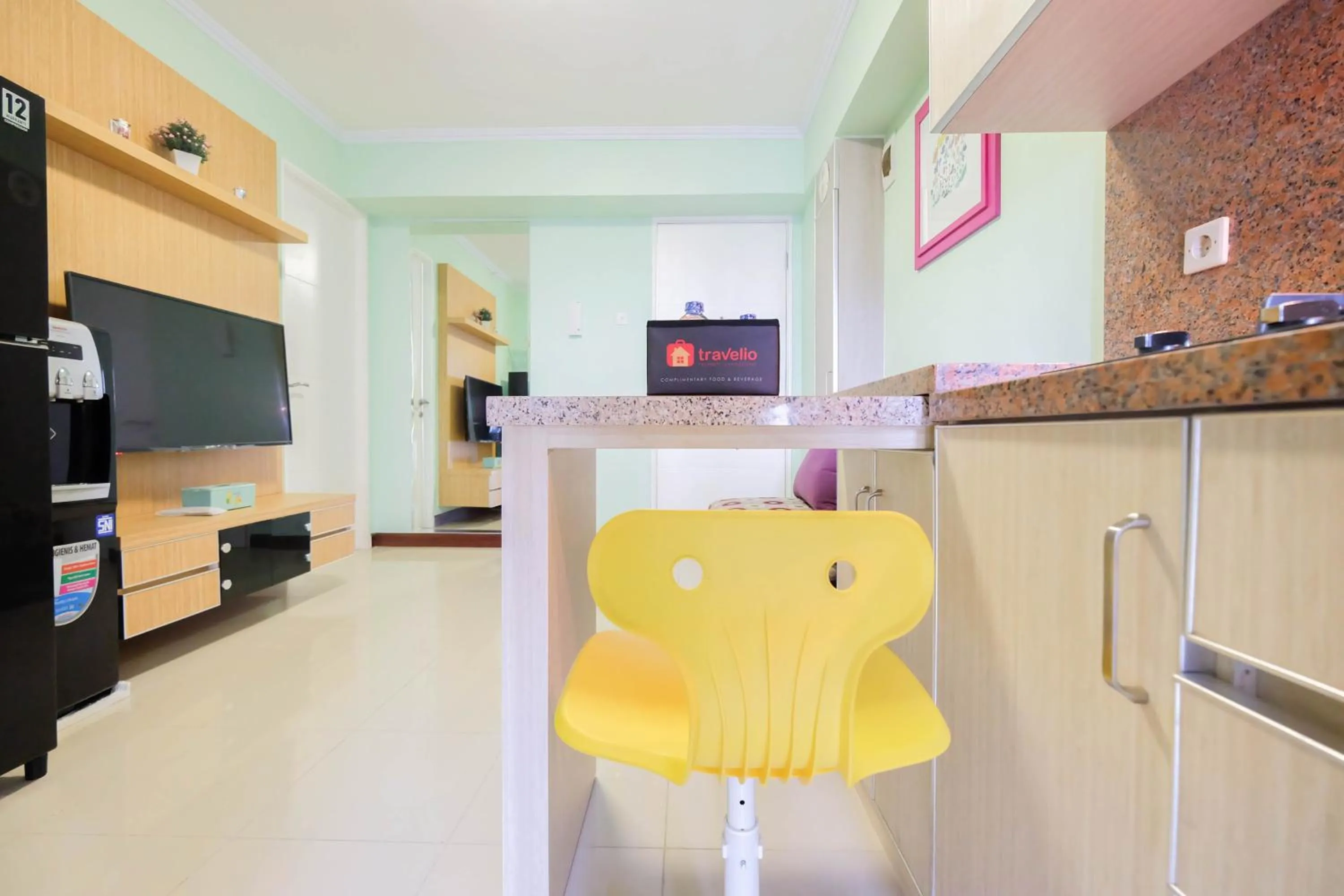 Kitchen or kitchenette in Cozy 2BR Bassura City Apartment By Travelio