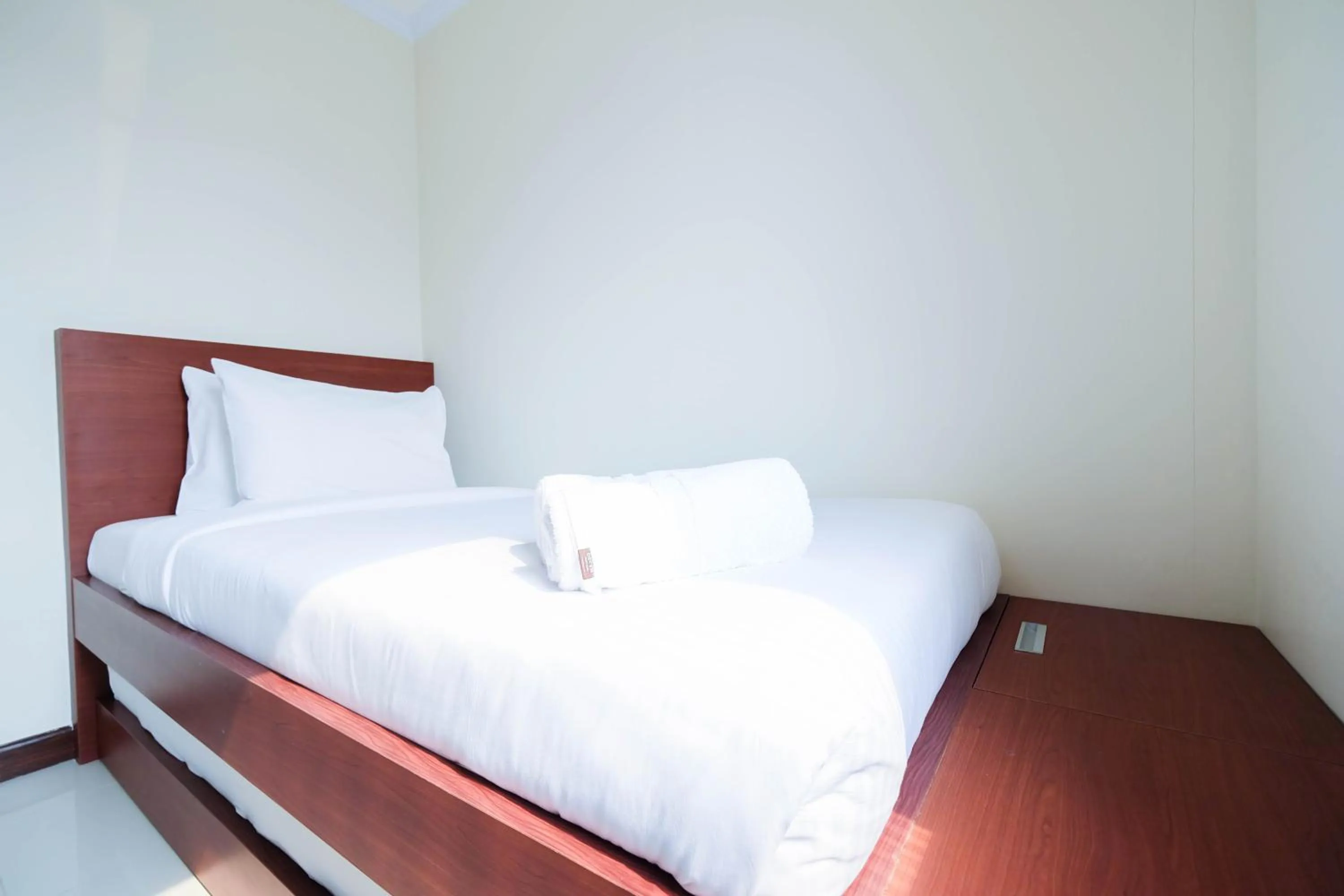 Bed in Cozy 2BR Bassura City Apartment By Travelio