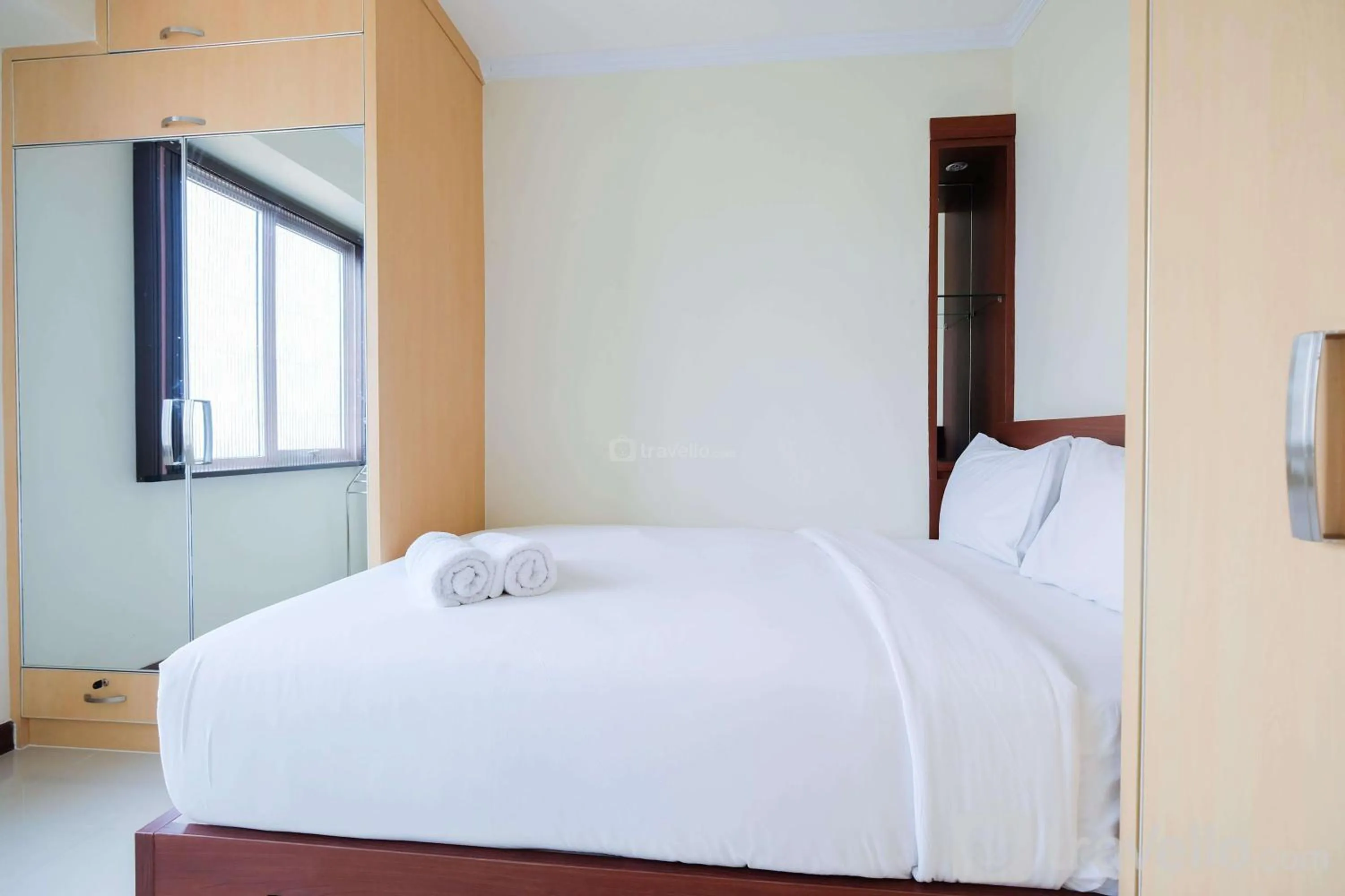 Bed in Cozy 2BR Bassura City Apartment By Travelio