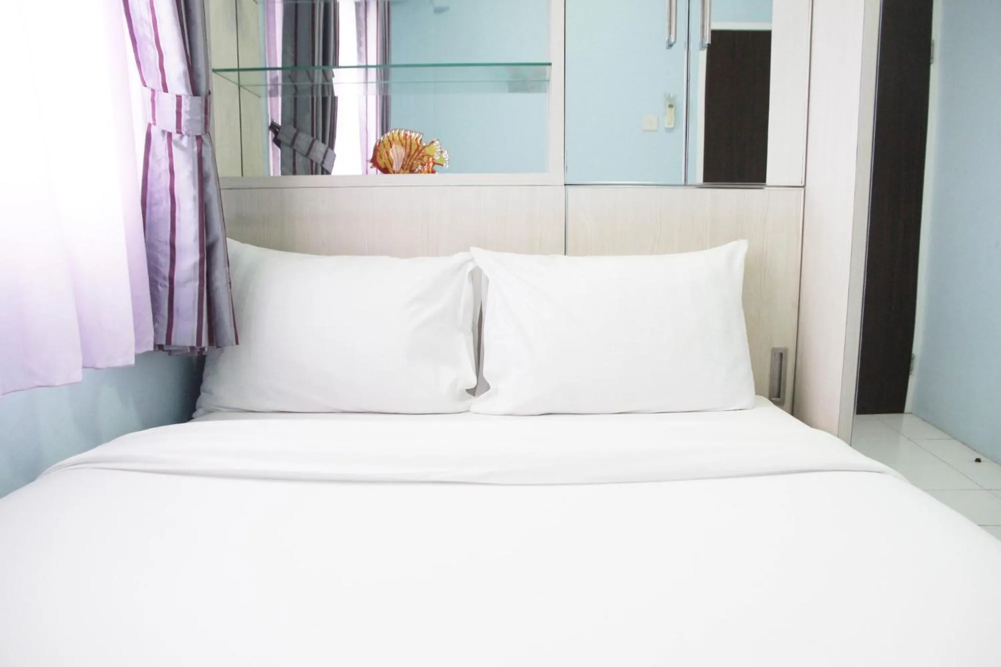 Bed in Comfortable 2BR Mutiara Bekasi Apartment By Travelio