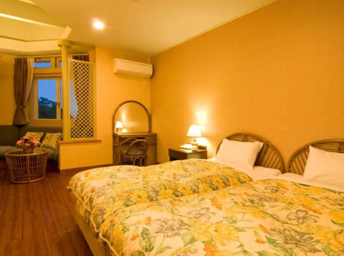 Bed in Petit Resort Hotel Alcyon