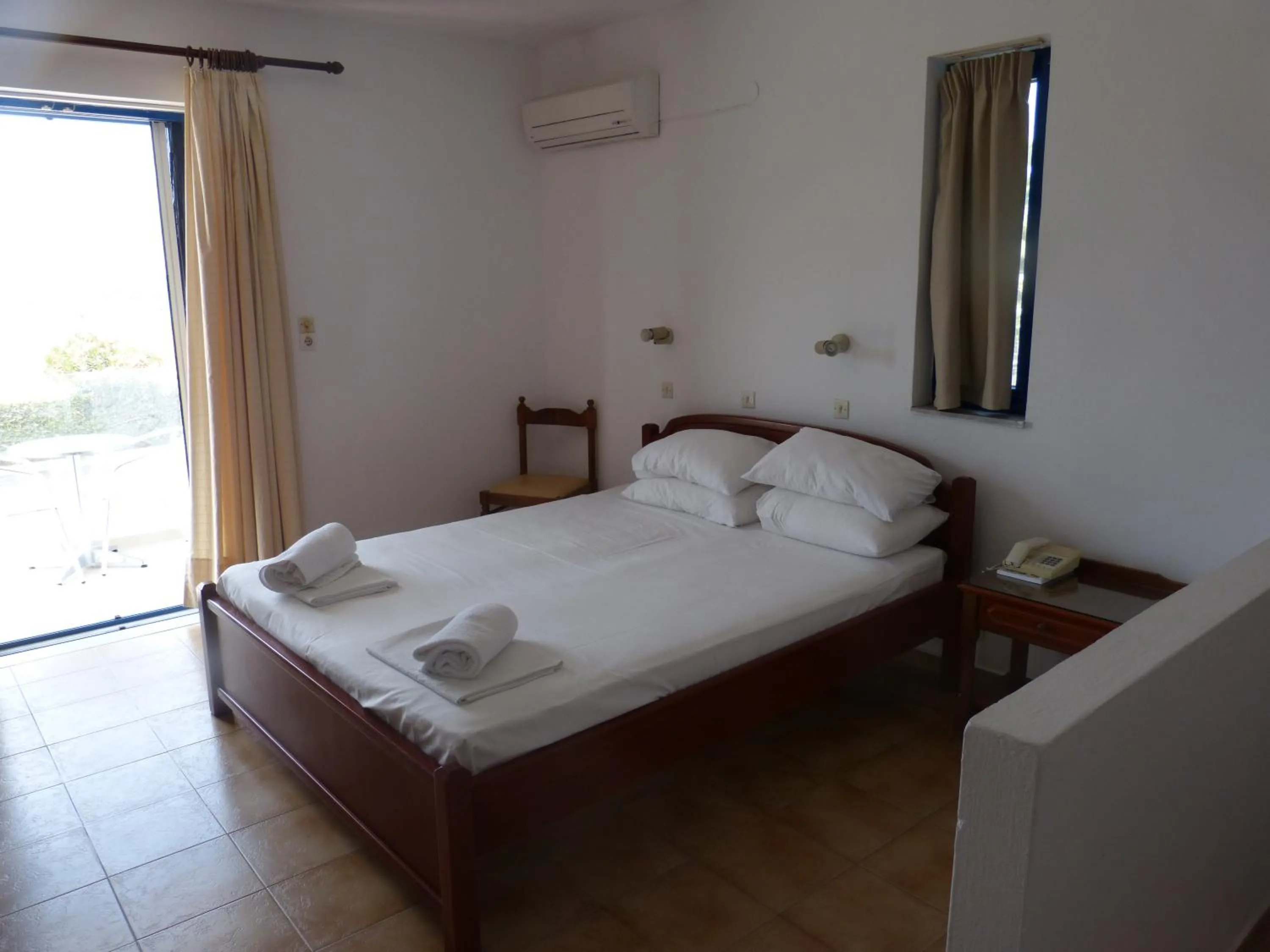 Bed in Miros Hotel Apartments