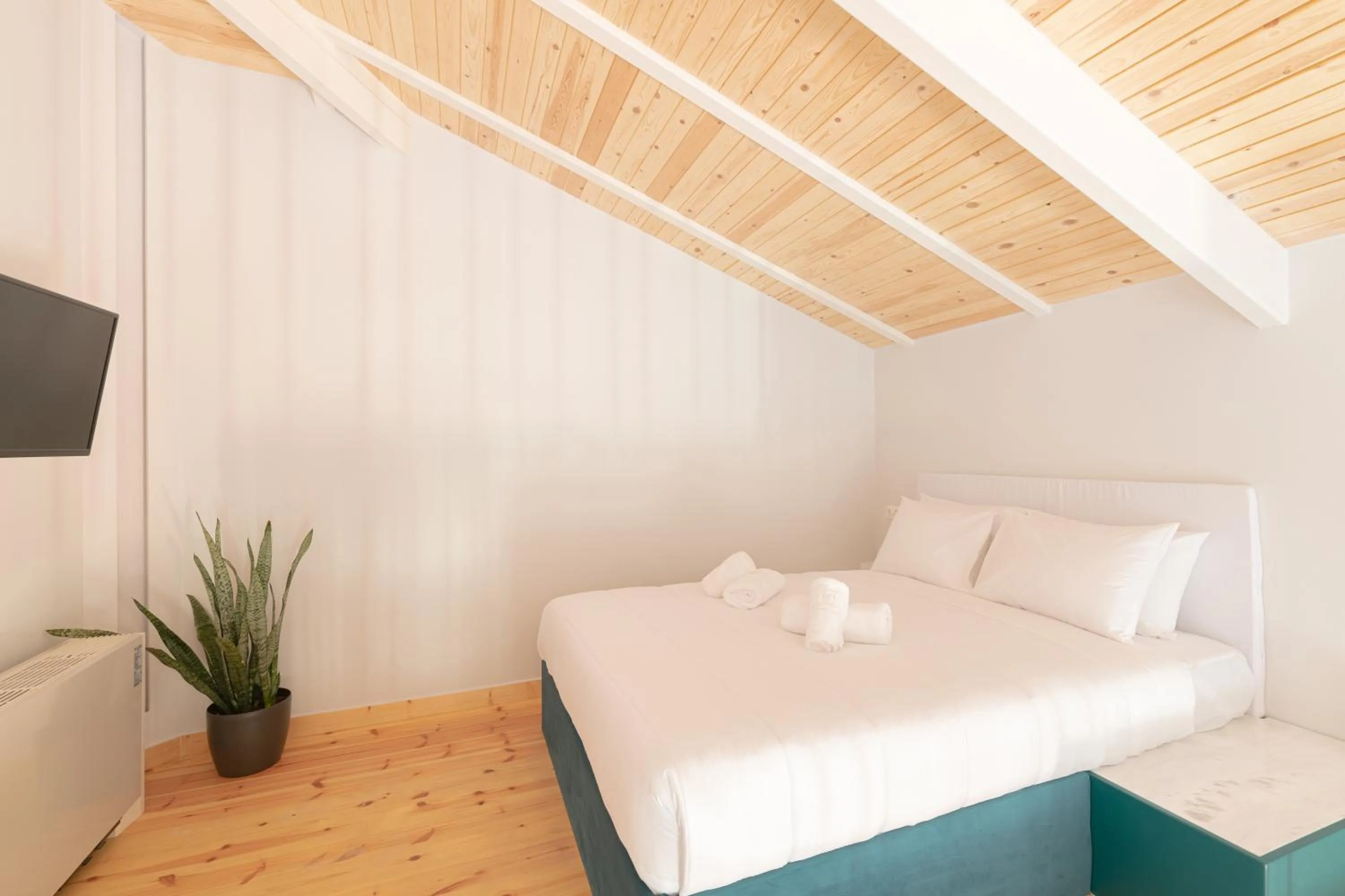 Bed in Ether Loft Suites