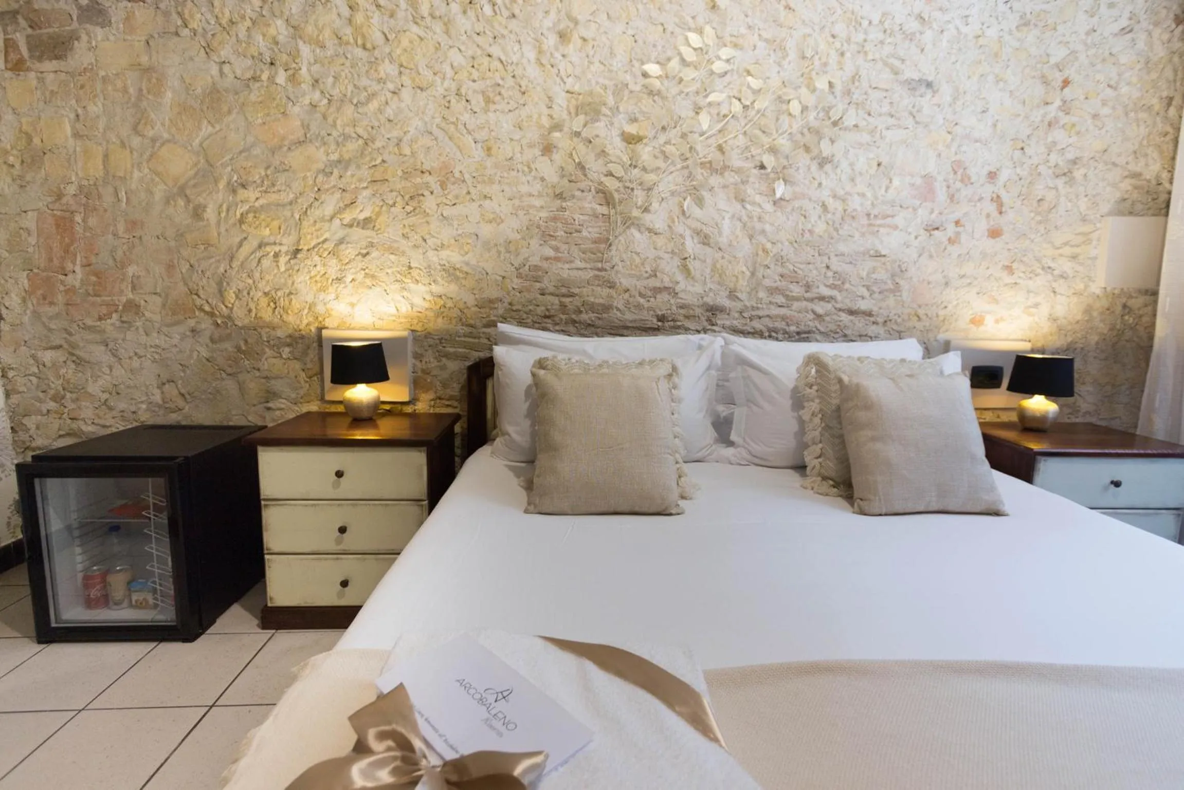 Bed in Arcobaleno Rooms