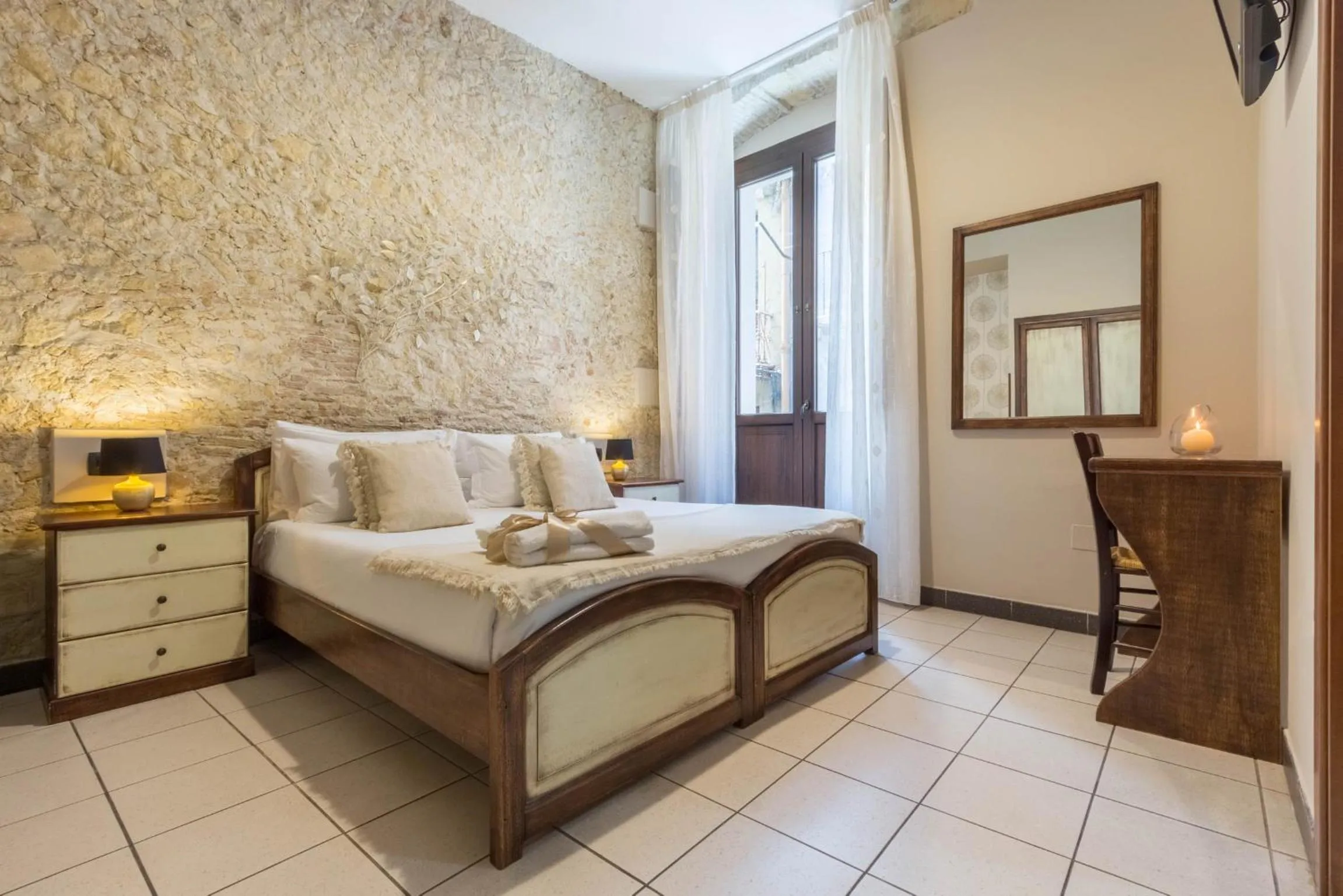 Bed in Arcobaleno Rooms