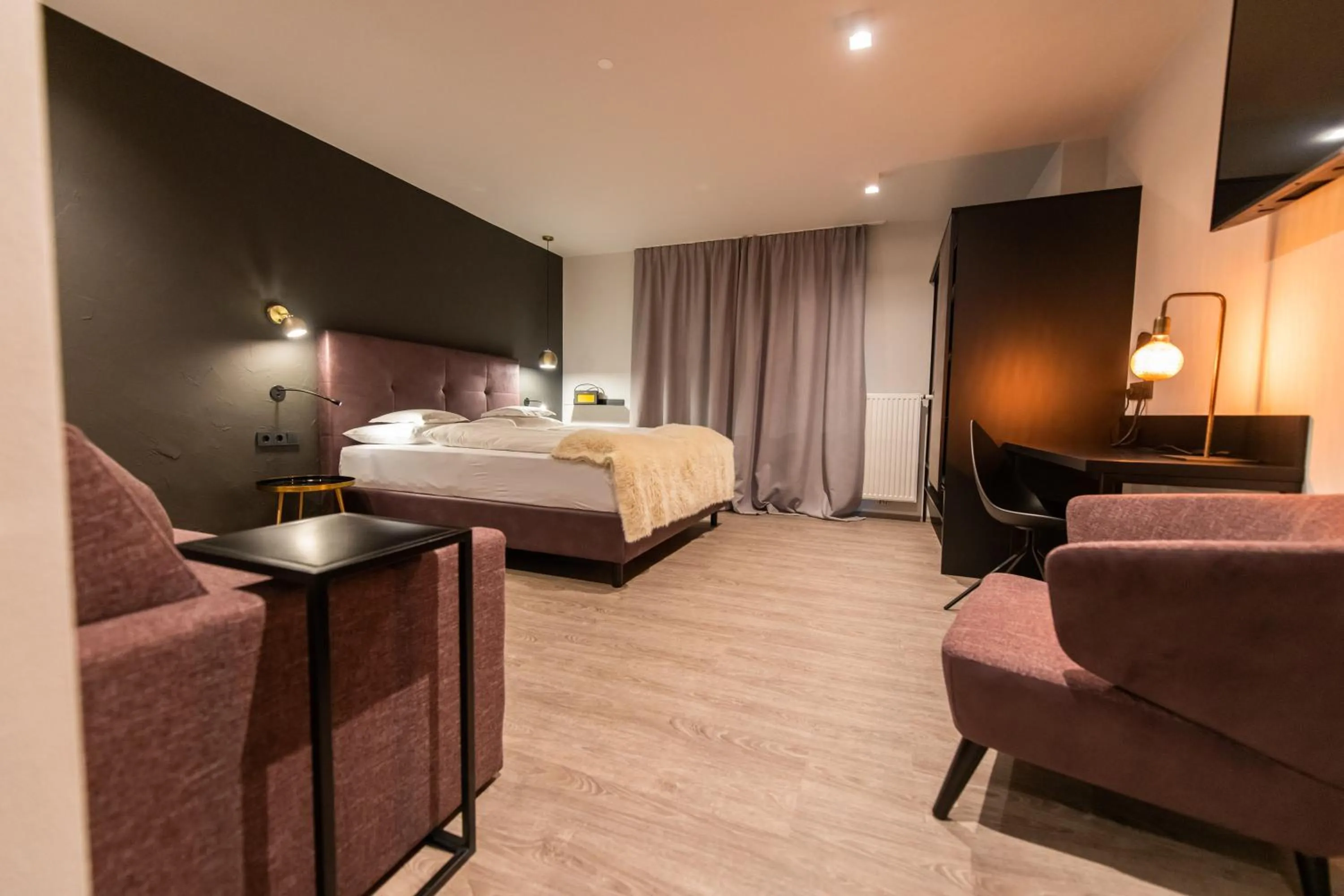 Seating area, Bed in Burgus - Design Suites & Apartments