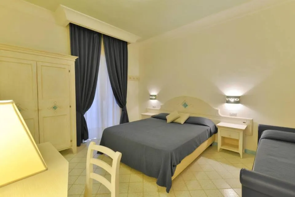 Bed in La Pineta Hotel Beach & Spa